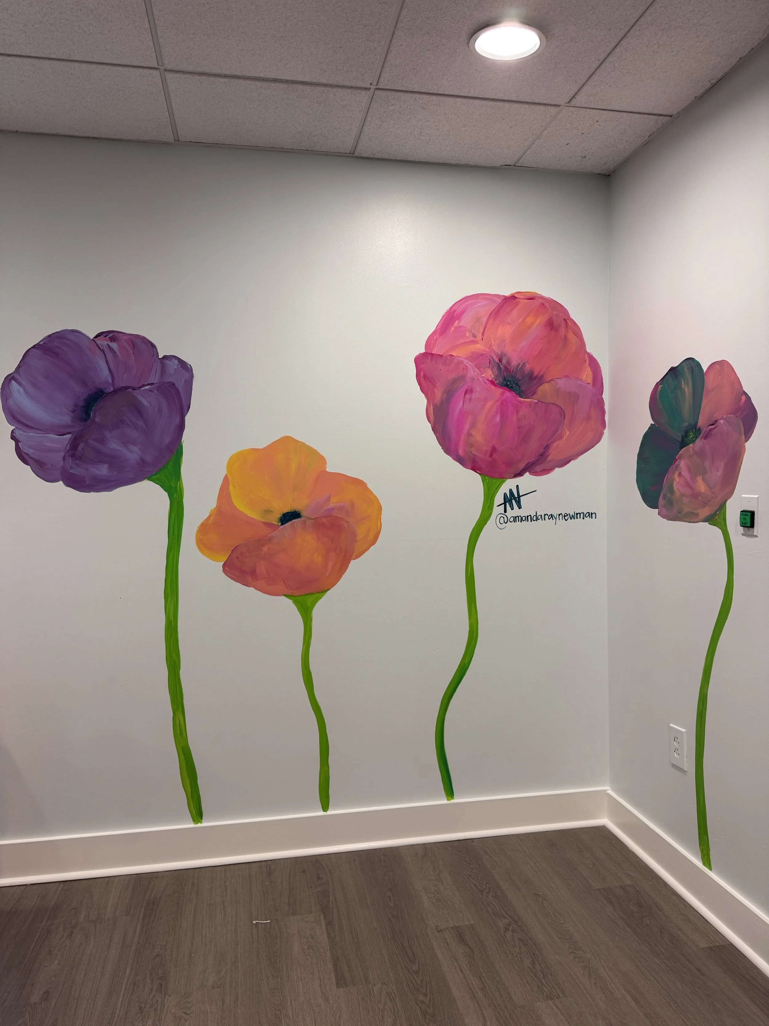 Giant Poppy photo op mural painted by Amanda Ray Newman in a preschool