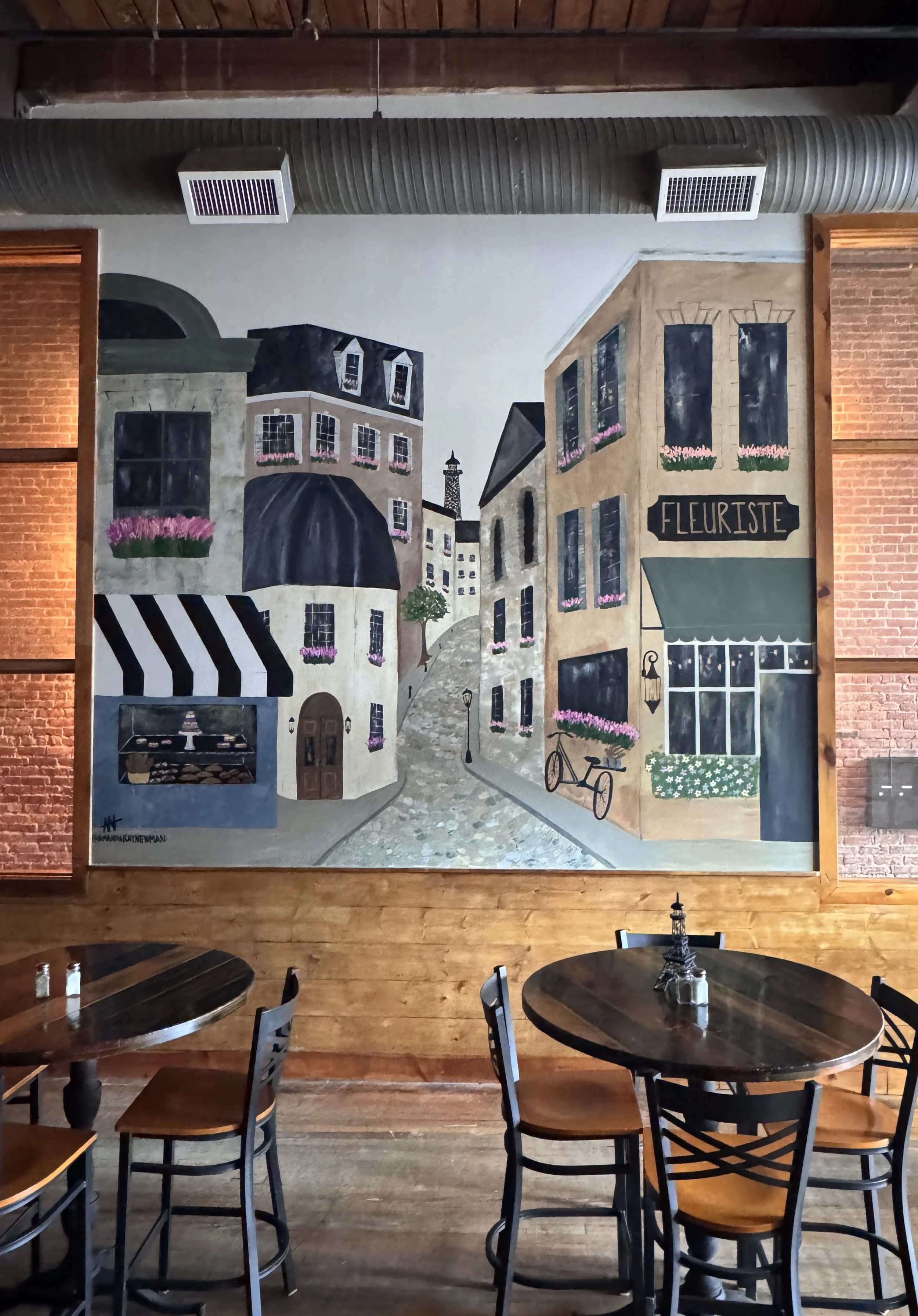 mural of Paris painted by Amanda Ray Newman in a French Bakery