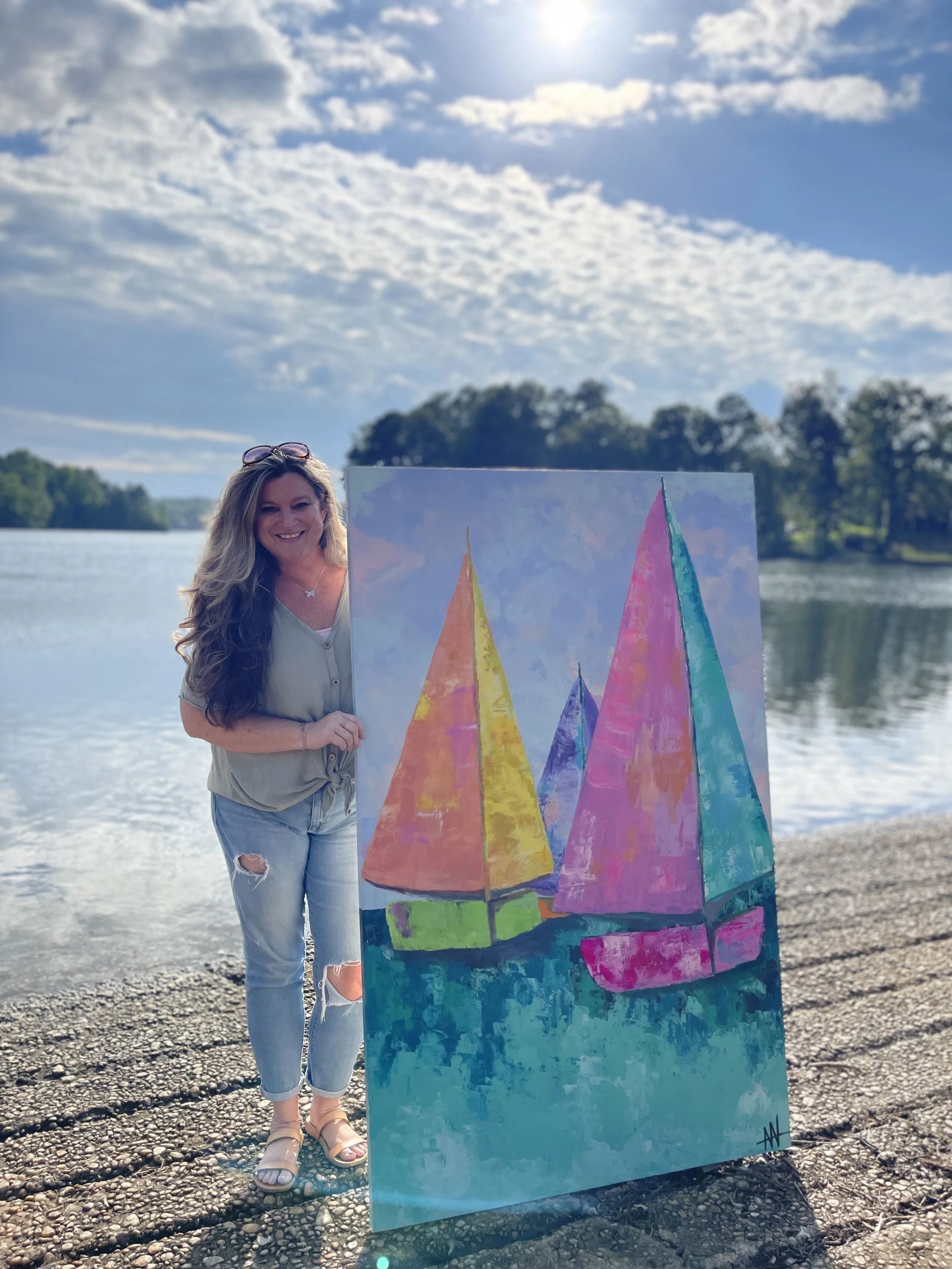 image of a talented artist with a large painting of sailboats