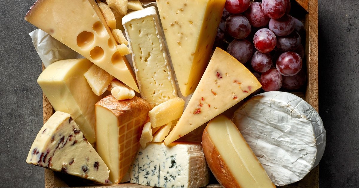 Various-Types-of-Cheese-with-Fresh-Grapes-in-a-Wooden-Board.jpg