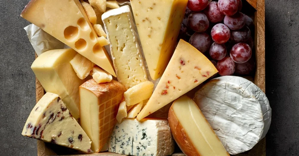 Various-Types-of-Cheese-with-Fresh-Grapes-in-a-Wooden-Board.jpg