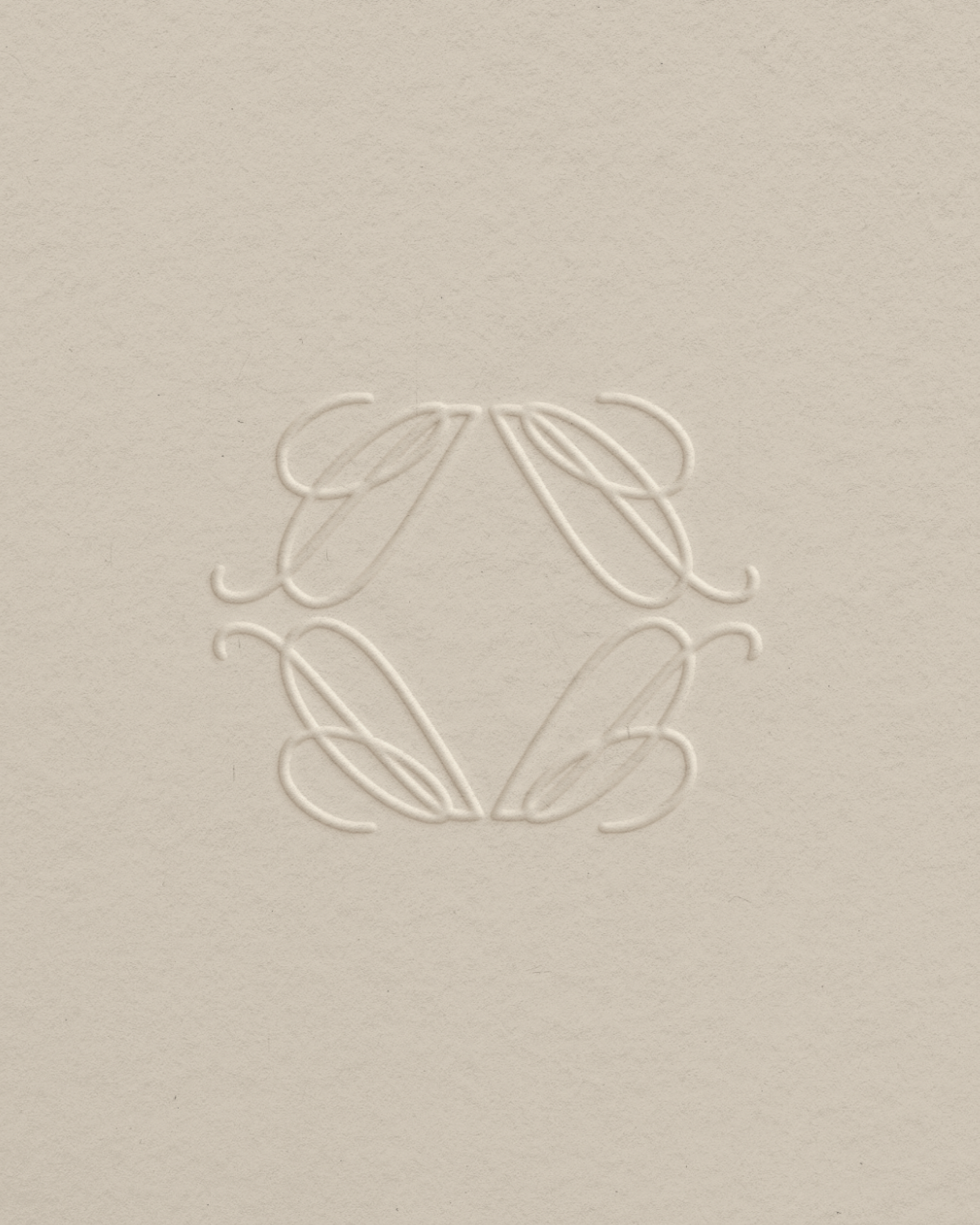 Embossed design of a stylized floral or leaf pattern on a beige surface.