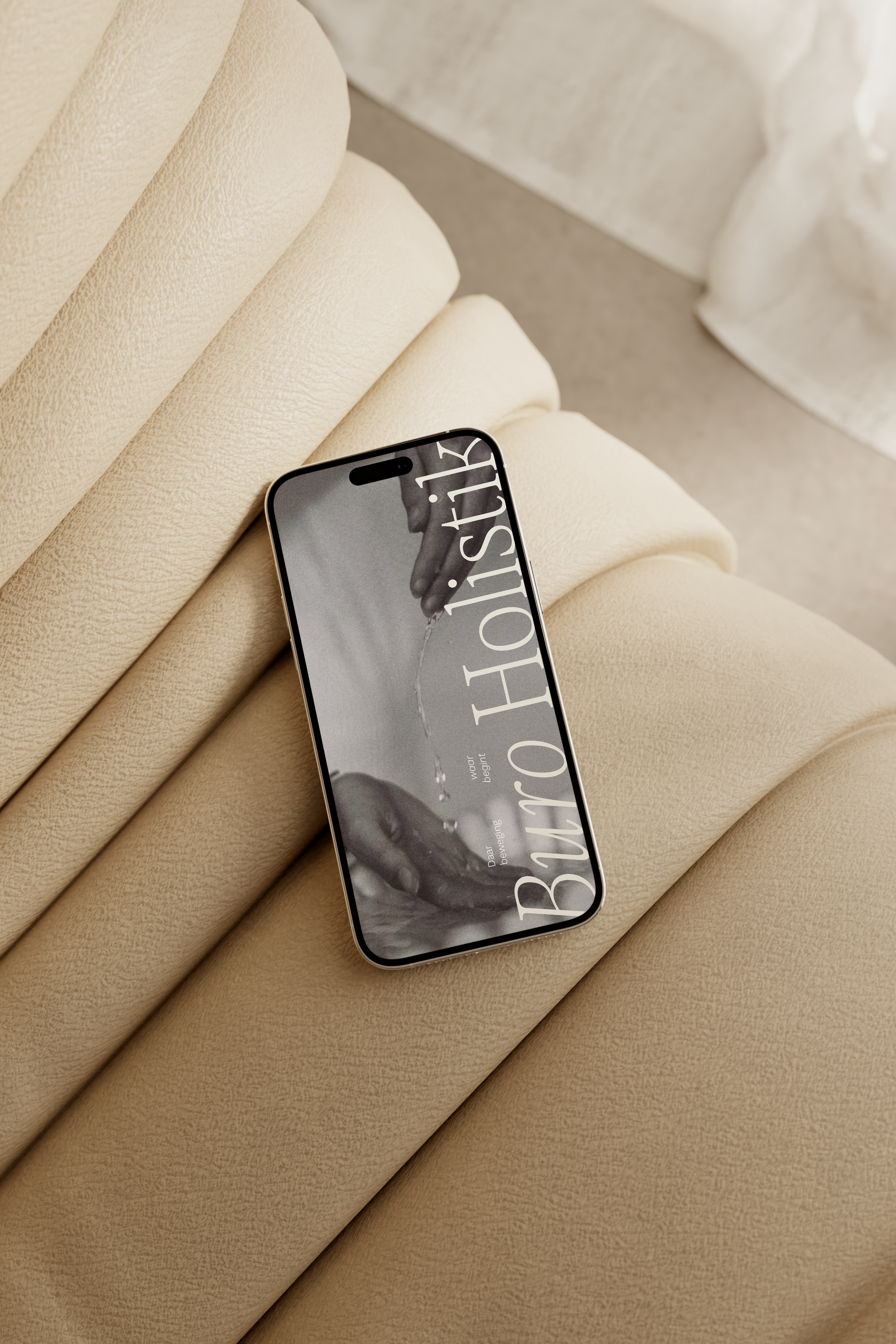 A smartphone with a black and white photo of hands holding a watering can on a beige fabric background.