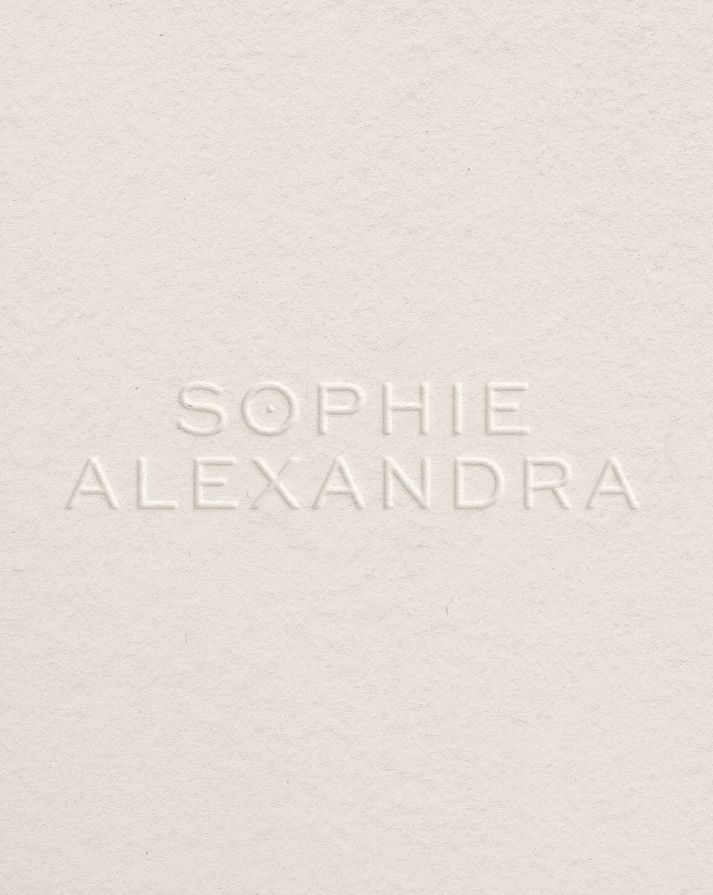 Embossed text 'SOPHIE ALEXANDRA' on a white textured background.