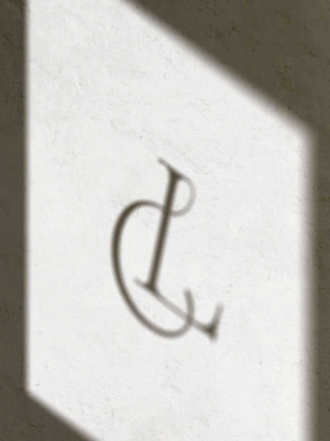 Close-up of a white object with a subtle embossed logo or symbol near the bottom right corner.