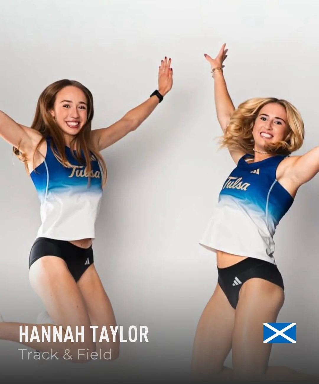 Two young women in athletic outfits celebrating, with one raising her arm and the other lowering her arm. They wear blue and white tops with 'Tulsa' written on them, black athletic shorts, and are smiling. The background is plain and light-colored.