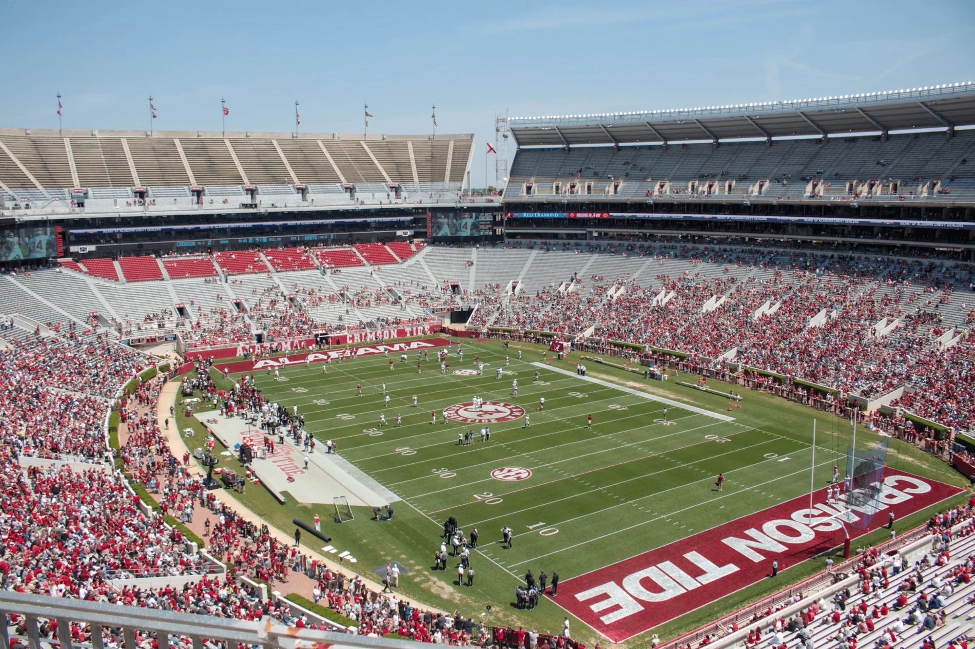 Packed US college football stadium on game day, the crowd filling every stand