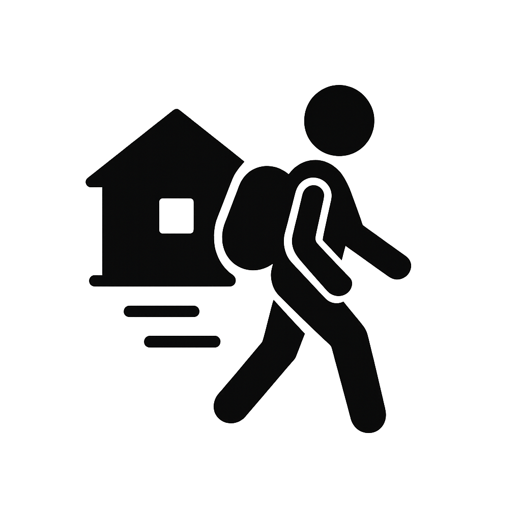 eine Person läuft mit Gepäck an einem Haus im Hintergrund vorbei