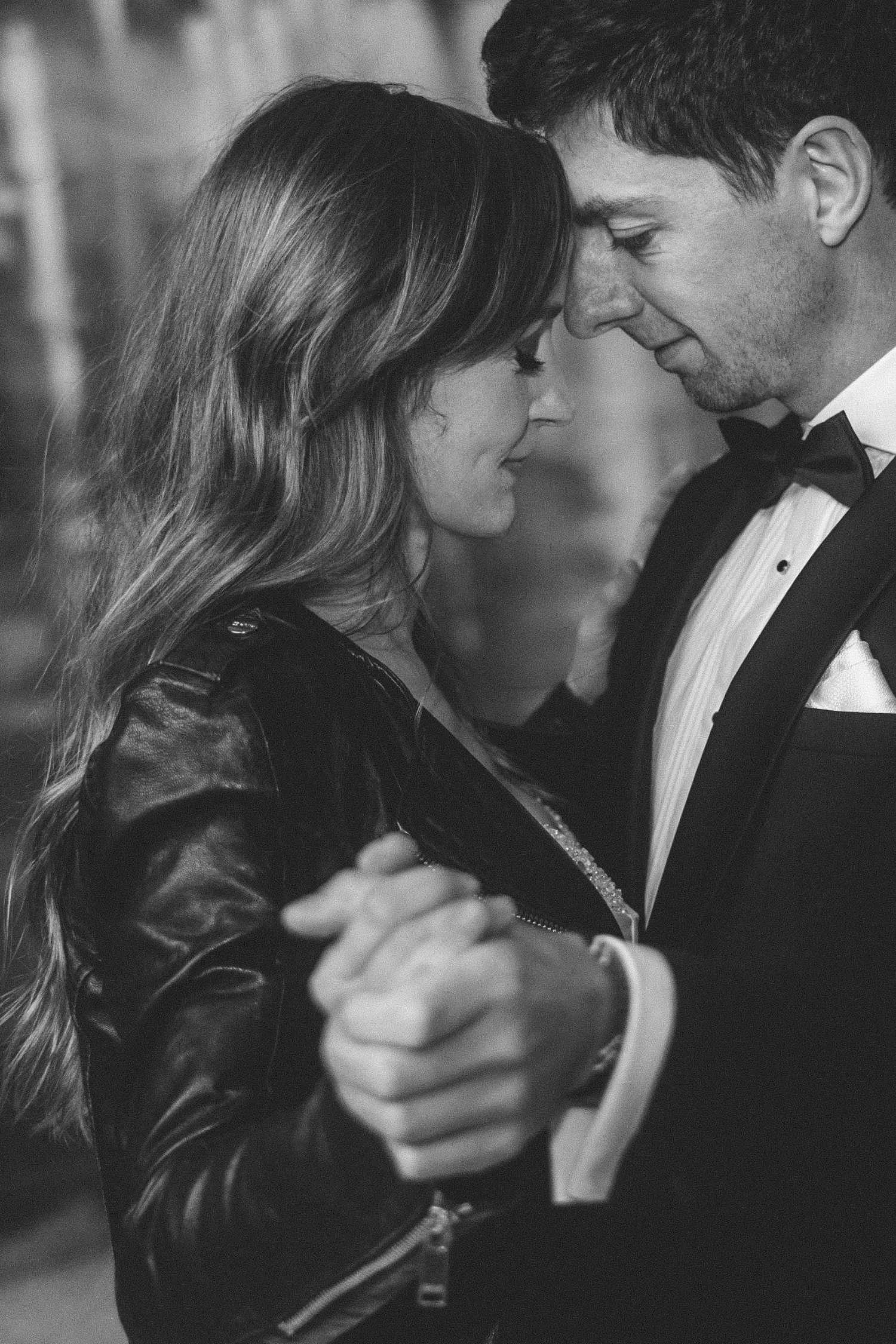 Black and white portrait of bride and groom holding hands during intimate wedding moment at Teufelsberg Berlin