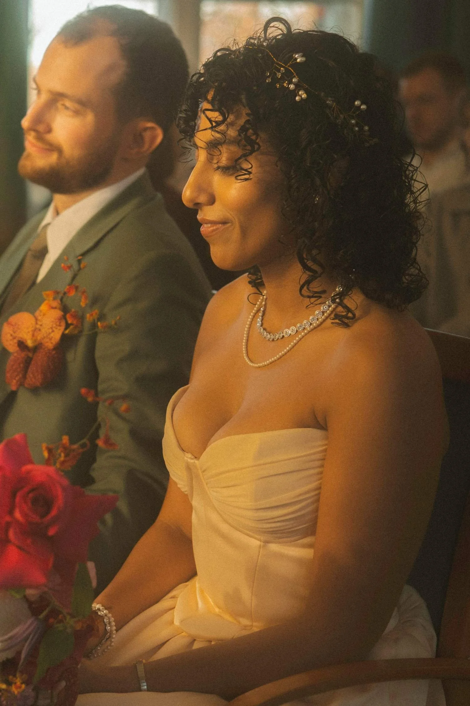 Bride and groom seated during a wedding ceremony at a registry office.