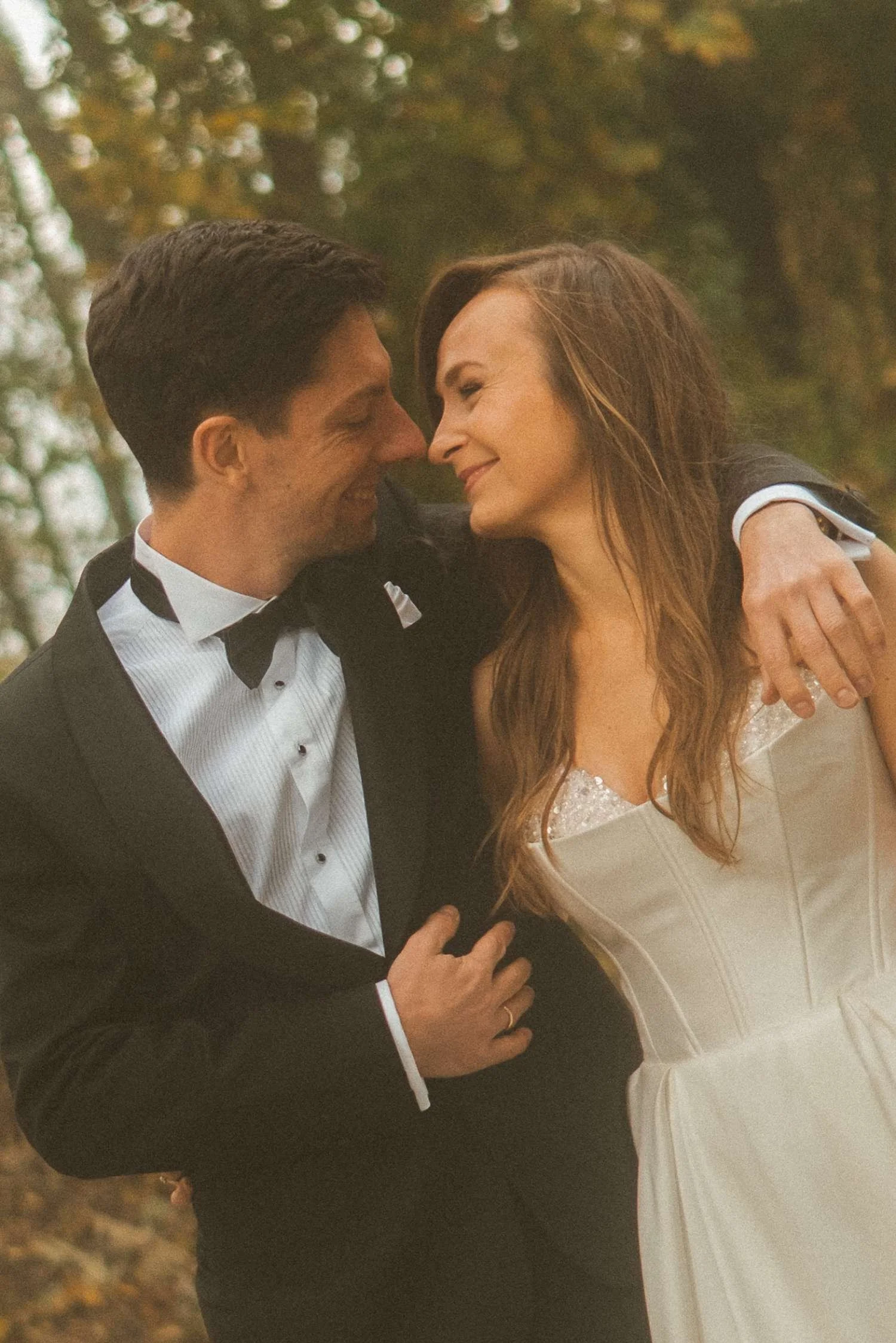 Bride and groom smiling at each other during autumn wedding photoshoot at Teufelsberg Berlin