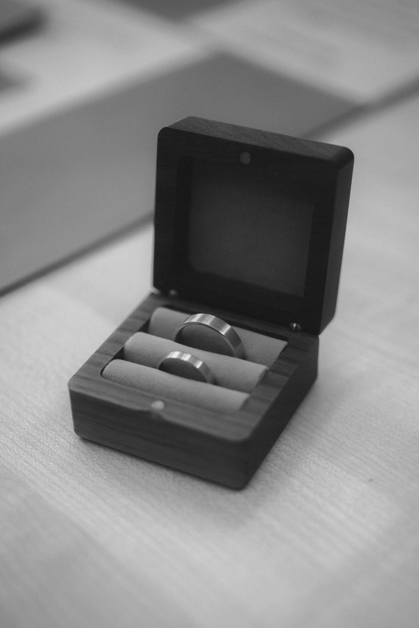 Close-up of two wedding bands in wooden ring box at Berlin Standesamt ceremony