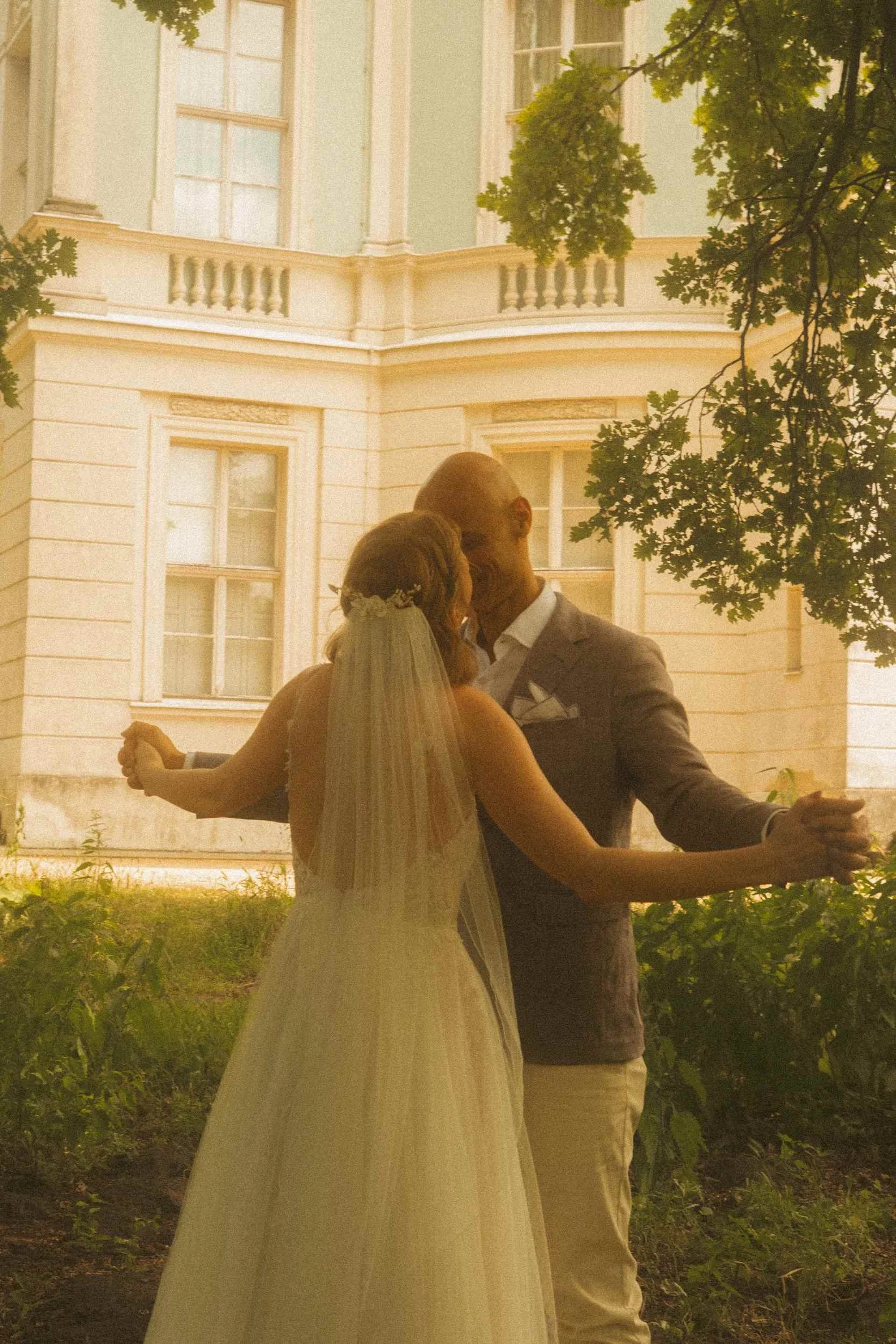 Couple dancing together near historic Berlin Standesamt building in warm golden light