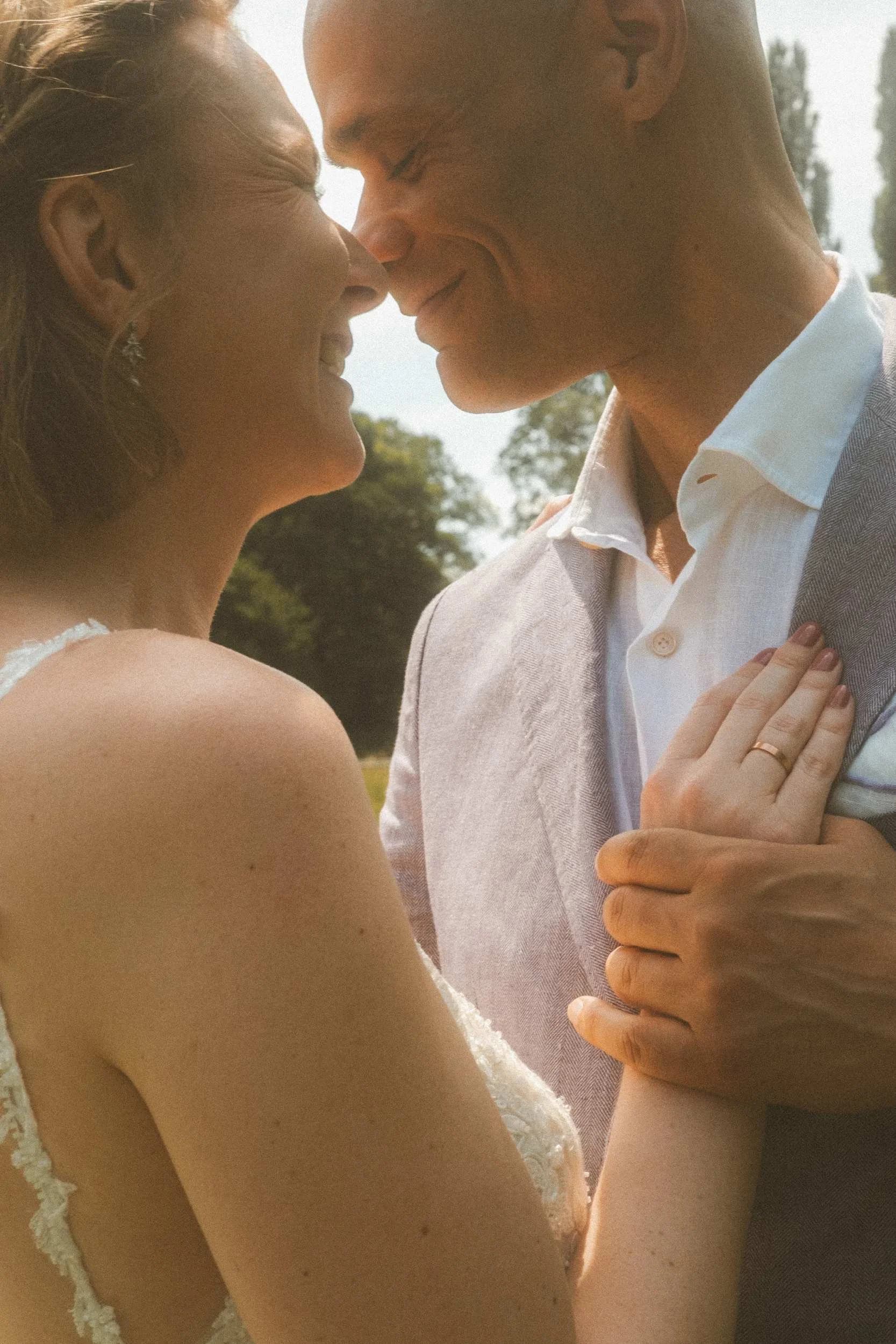 Couple smiling face to face in warm golden hour light at Berlin wedding portrait session