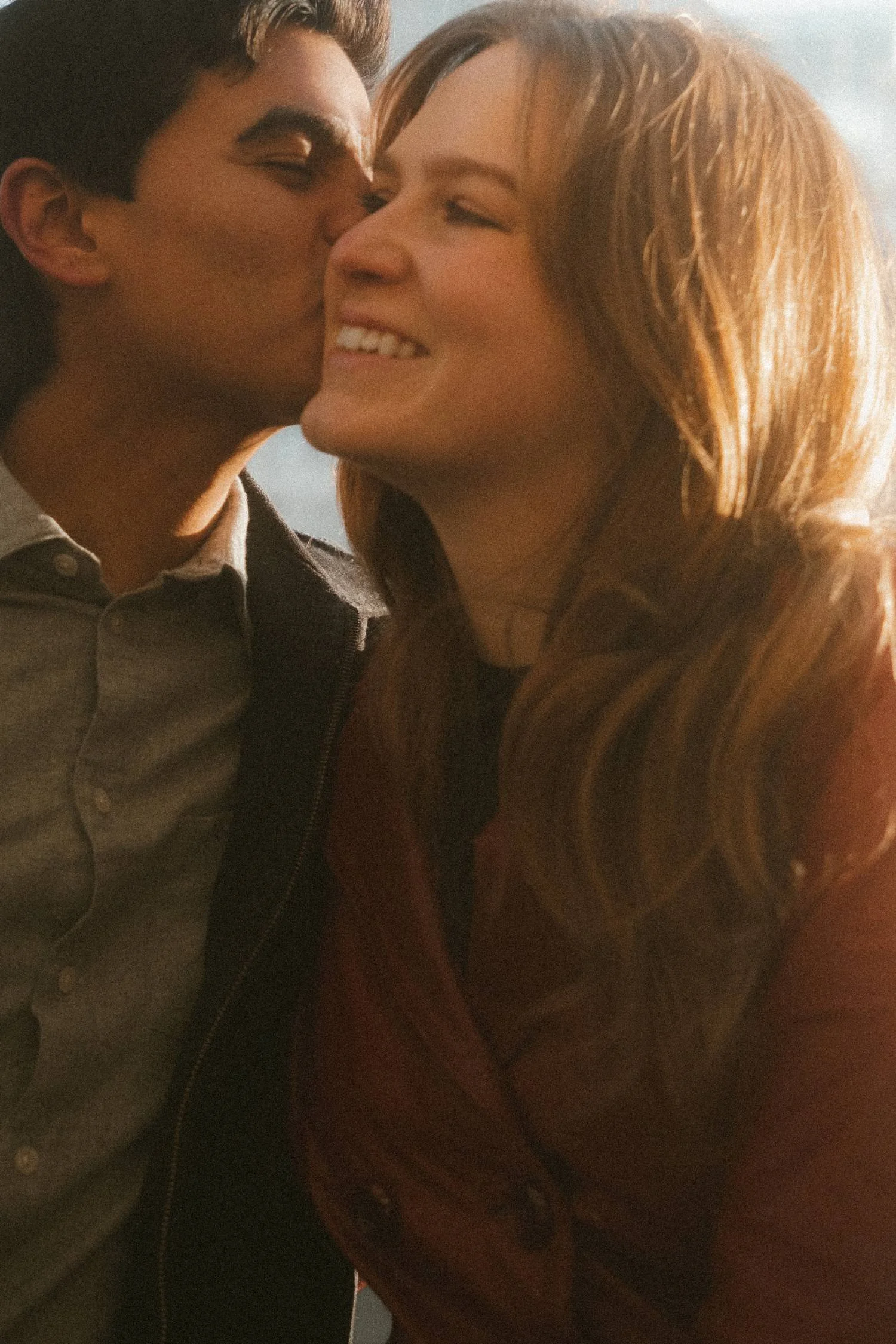 Close-up couple portrait in Berlin during golden hour, capturing an intimate and natural moment