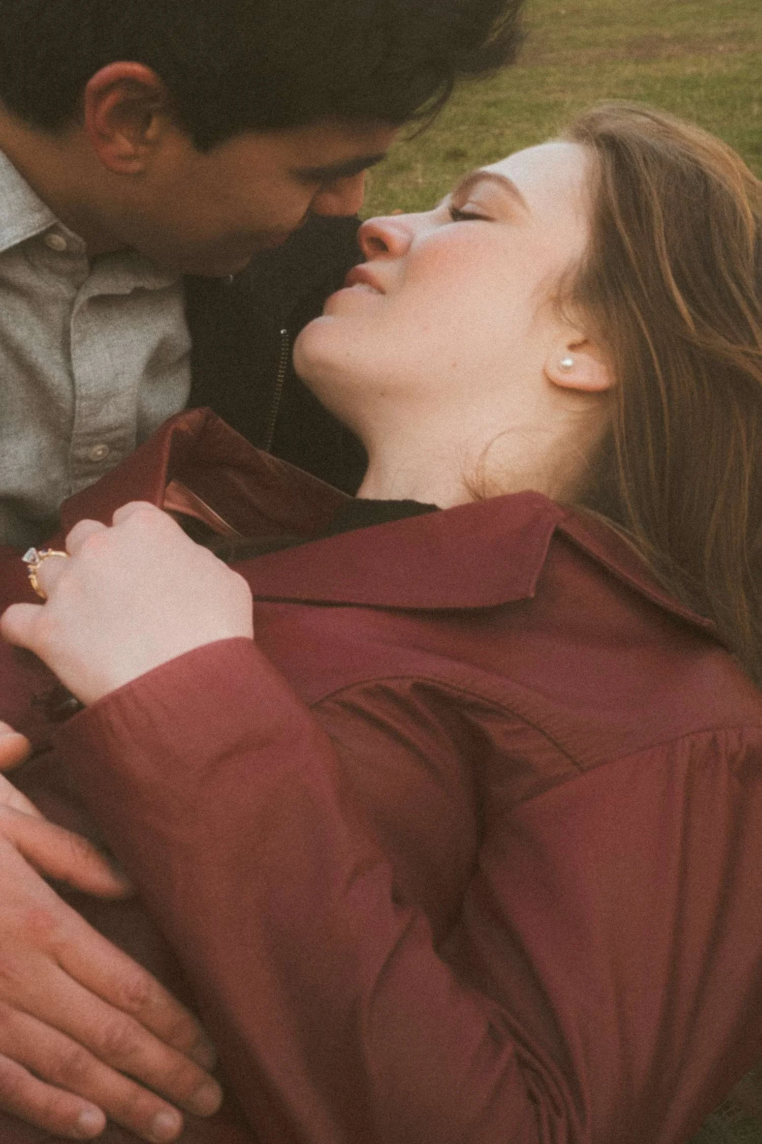 Romantic close up of a couple embracing during an engagement photoshoot in Berlin, captured in natural light with an intimate cinematic feel.