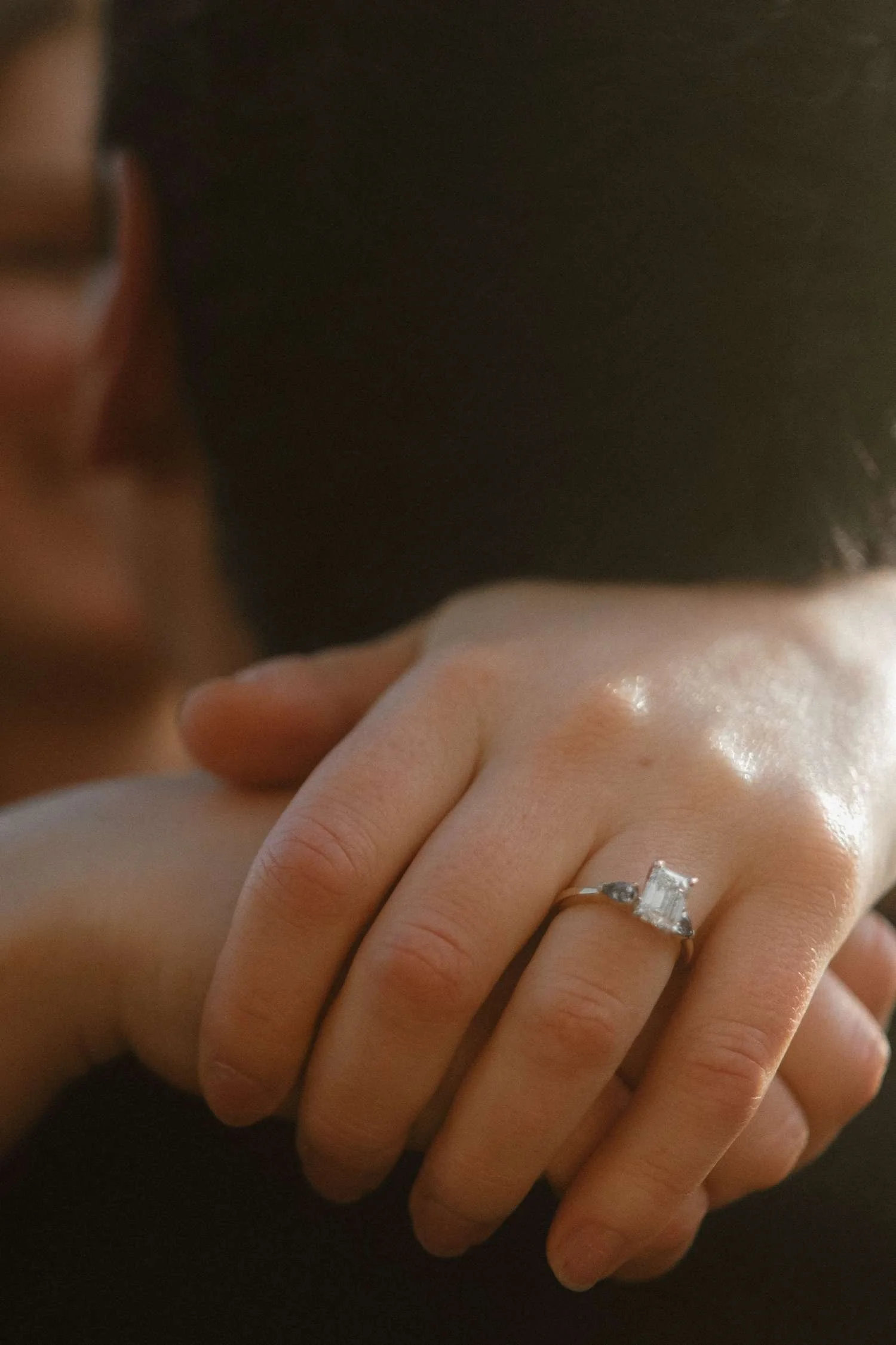 Close-up of engagement ring on hand during a surprise proposal in Berlin, natural light, intimate moment