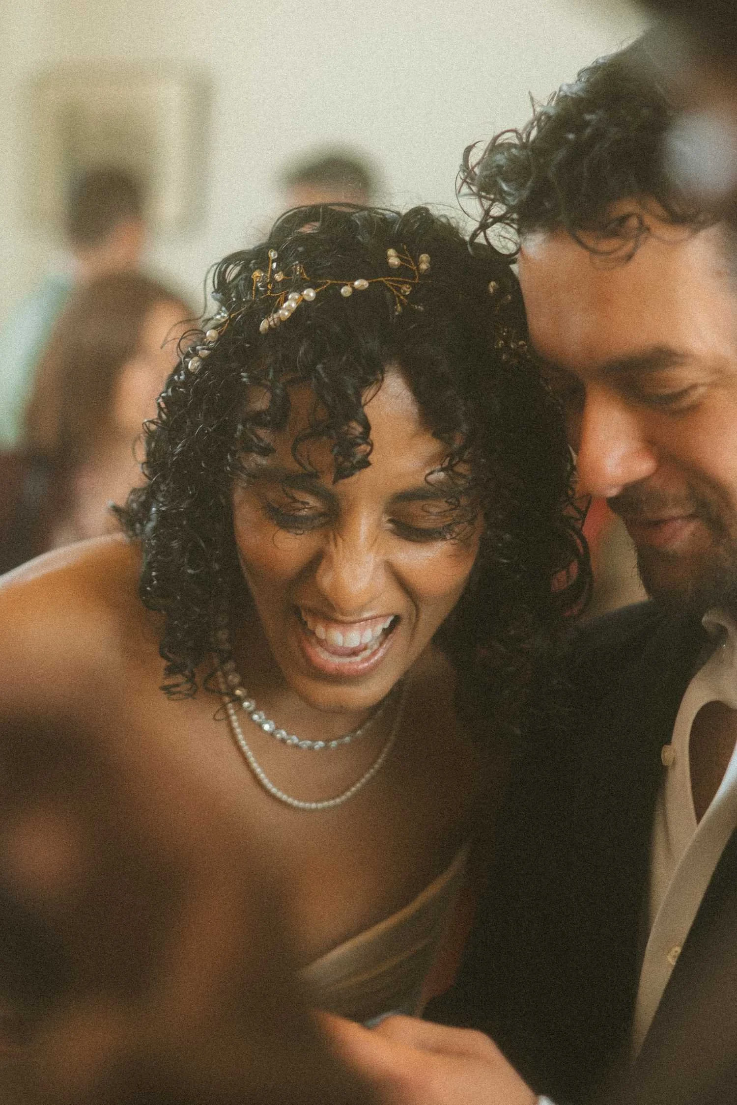 Bride laughing during an intimate Standesamt wedding ceremony in Berlin as she shares a quiet moment with her partner