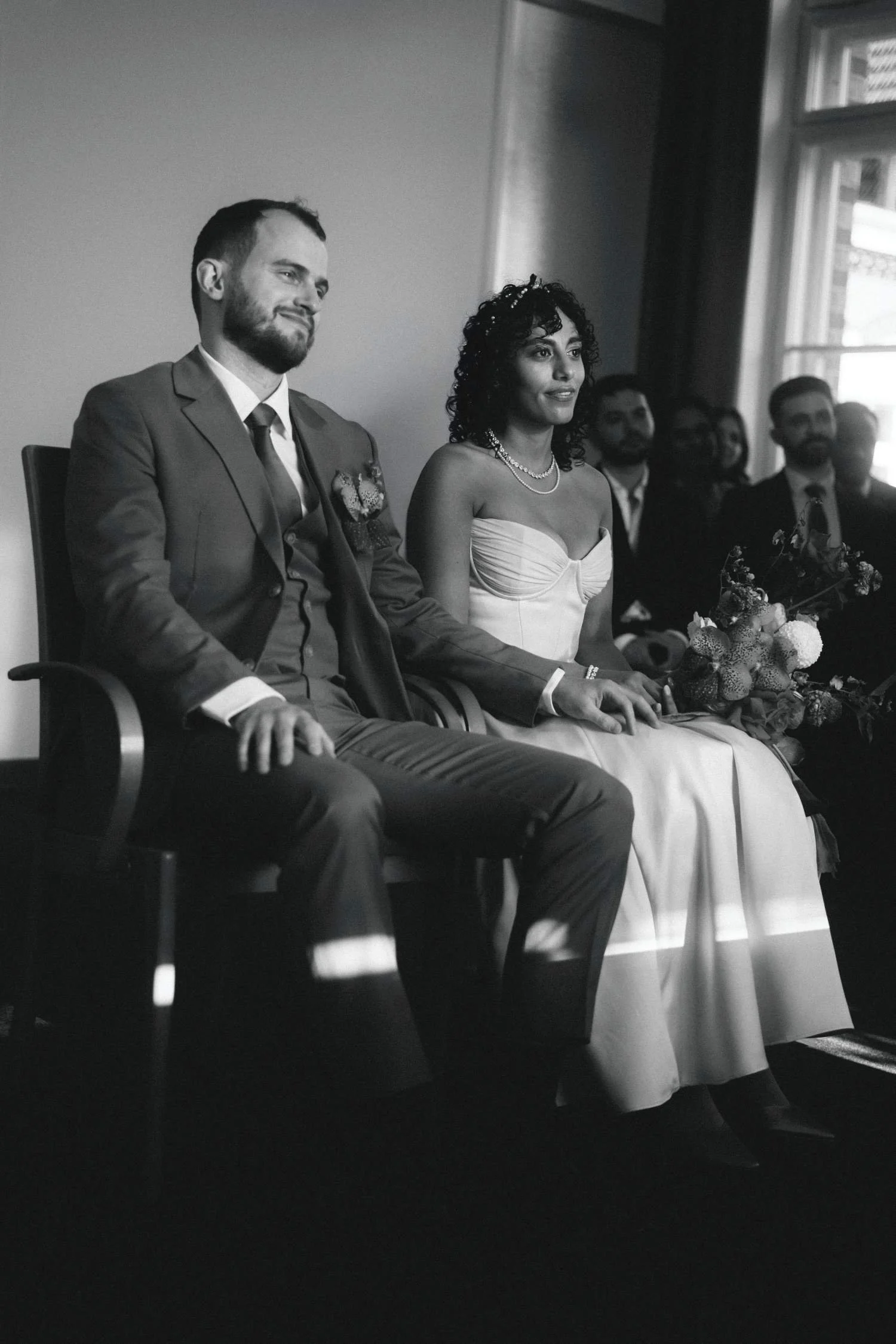 Bride and groom seated together during a wedding ceremony.