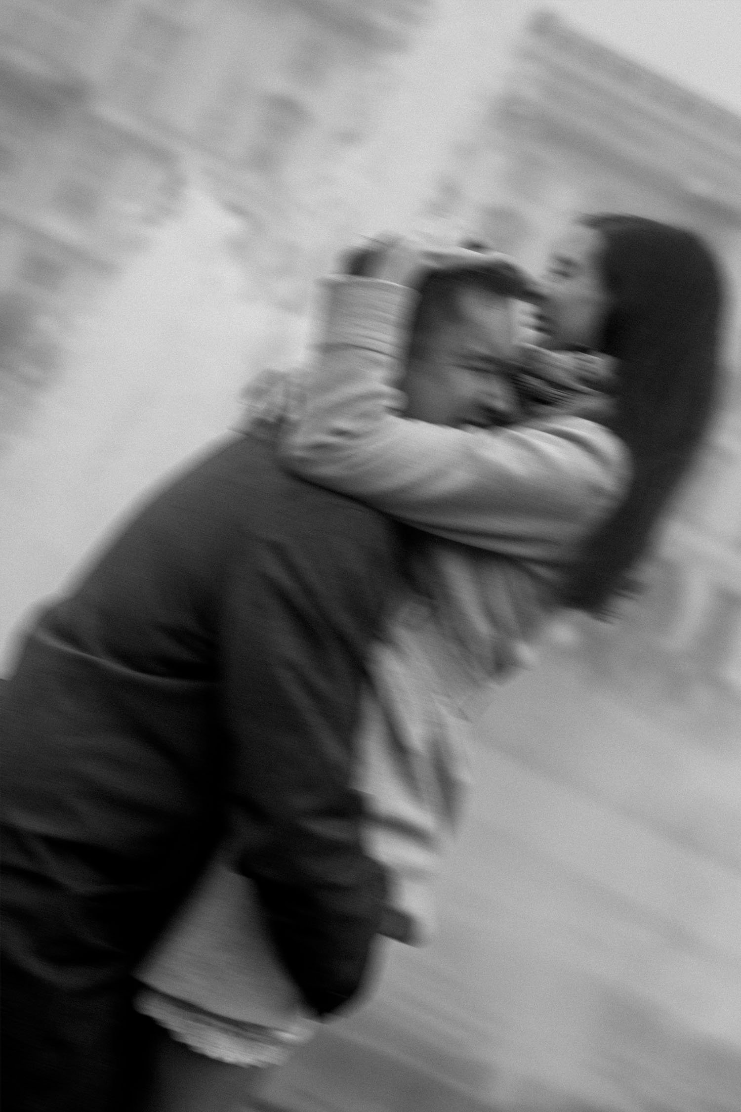 Artistic black and white portrait of couple embracing with motion blur during Berlin photoshoot