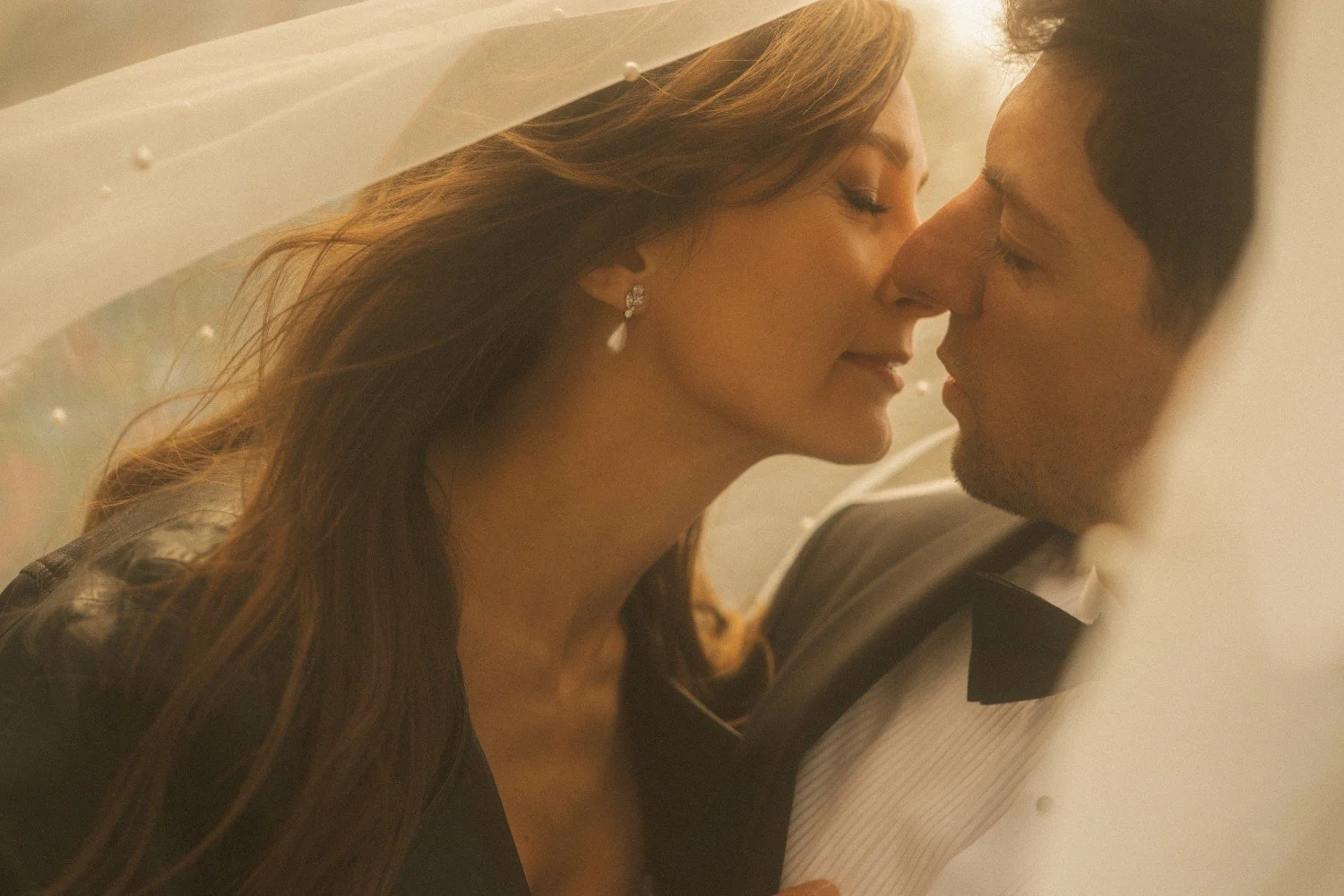 Close-up of bride and groom under veil during intimate wedding moment at Teufelsberg Berlin