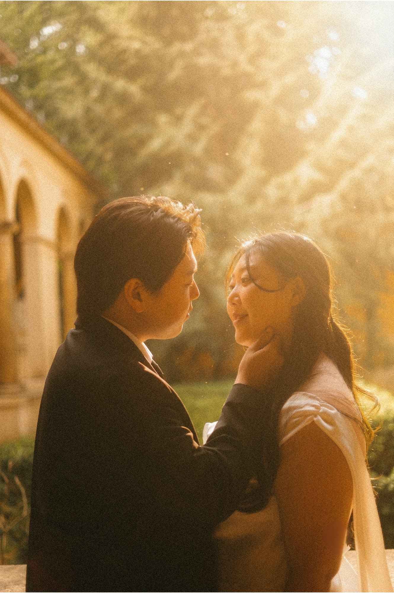 An intimate, close-up wedding portrait of a groom gently holding and embracing the bride's face during golden hour in Potsdam.