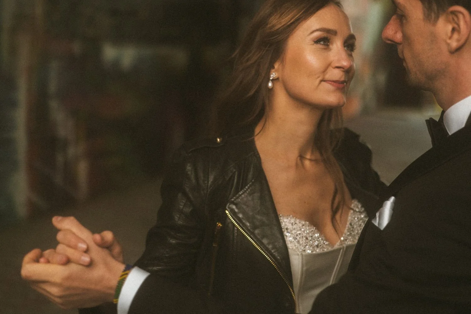 Bride and groom holding hands while dancing during cinematic wedding photoshoot at Teufelsberg Berlin