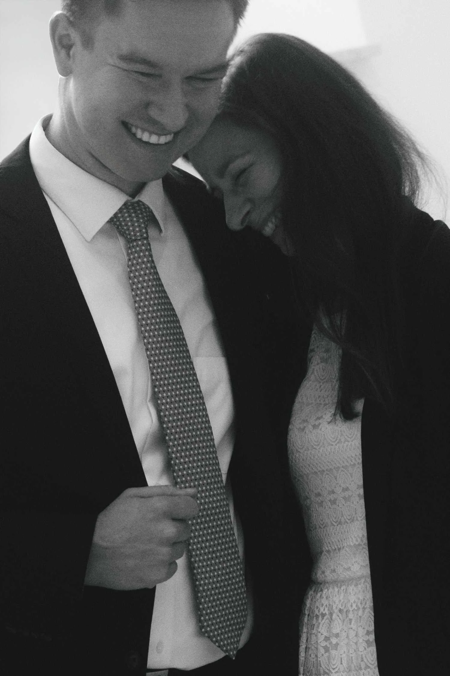 Black and white portrait of couple smiling closely together after proposal during Berlin photoshoot
