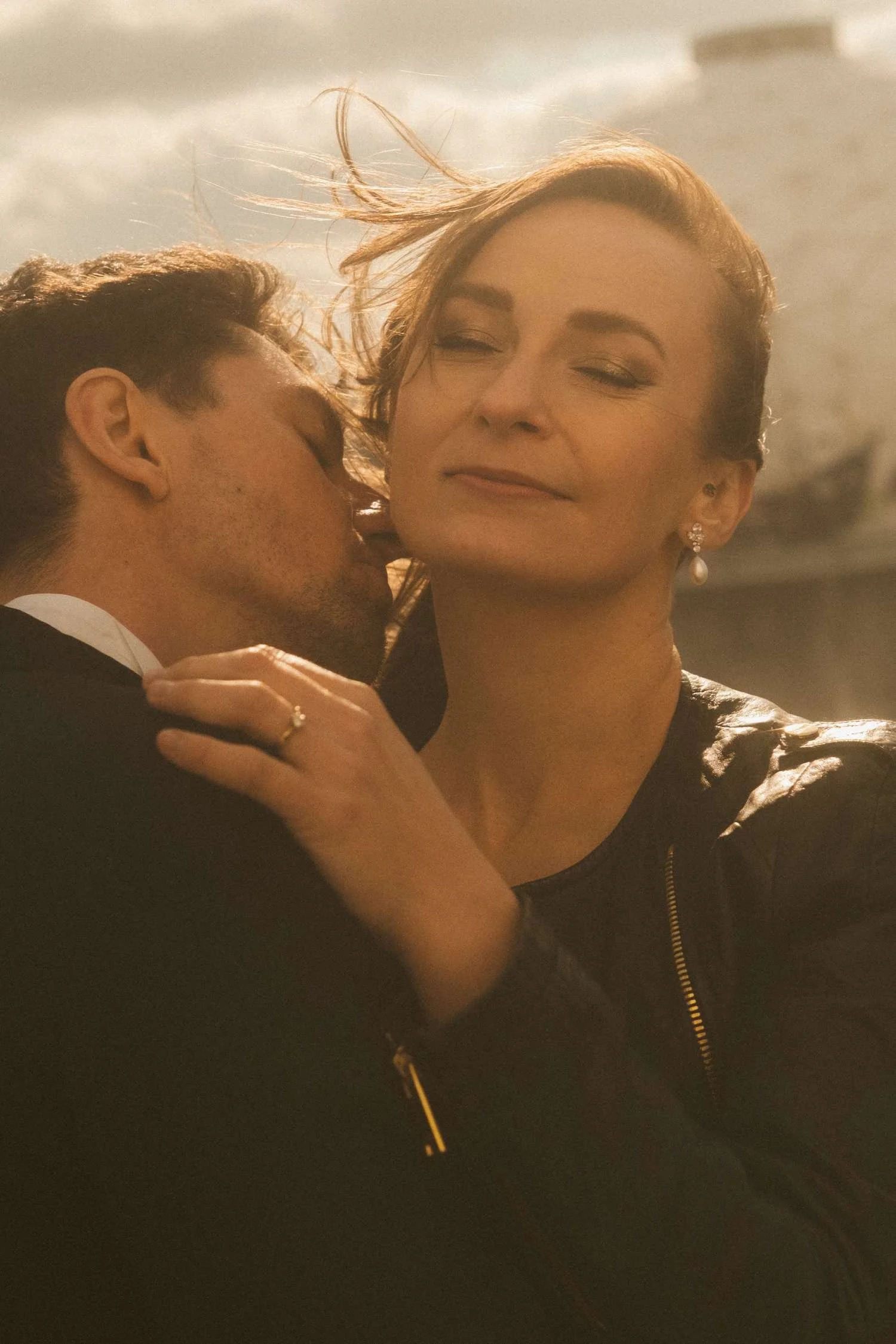 Bride and groom embracing during golden hour wedding photoshoot at Teufelsberg Berlin with soft cinematic light
