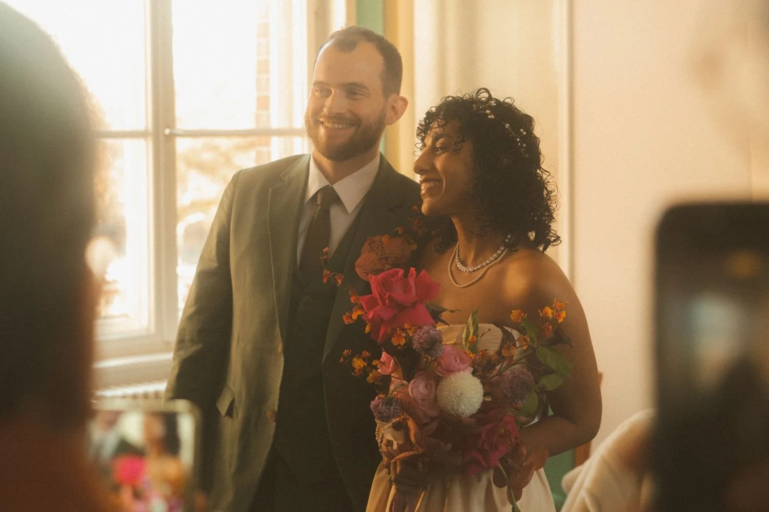 Bride and groom smiling together during an intimate Standesamt wedding ceremony in Berlin with warm natural light
