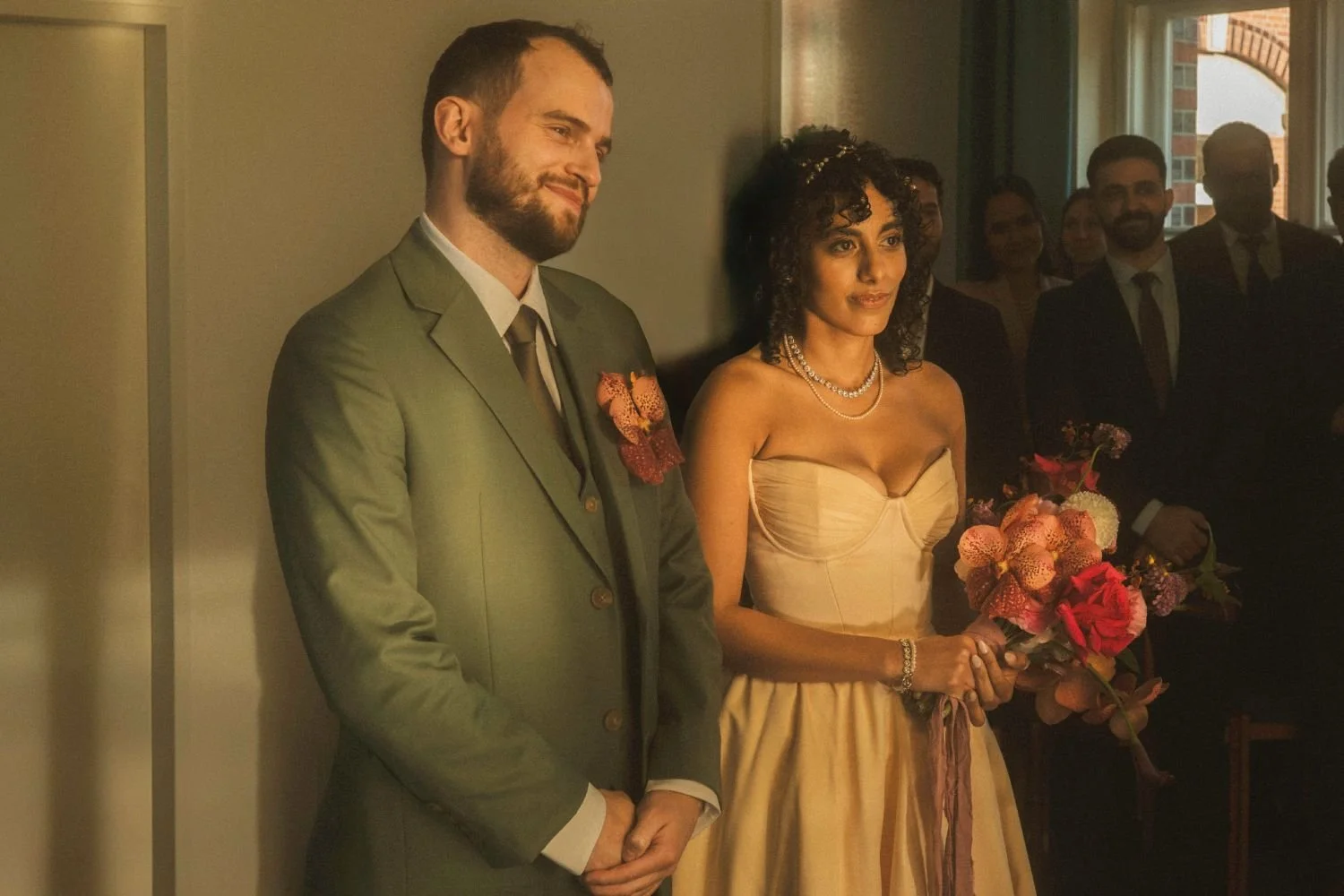 Bride and groom standing together during a wedding ceremony at a registry office.