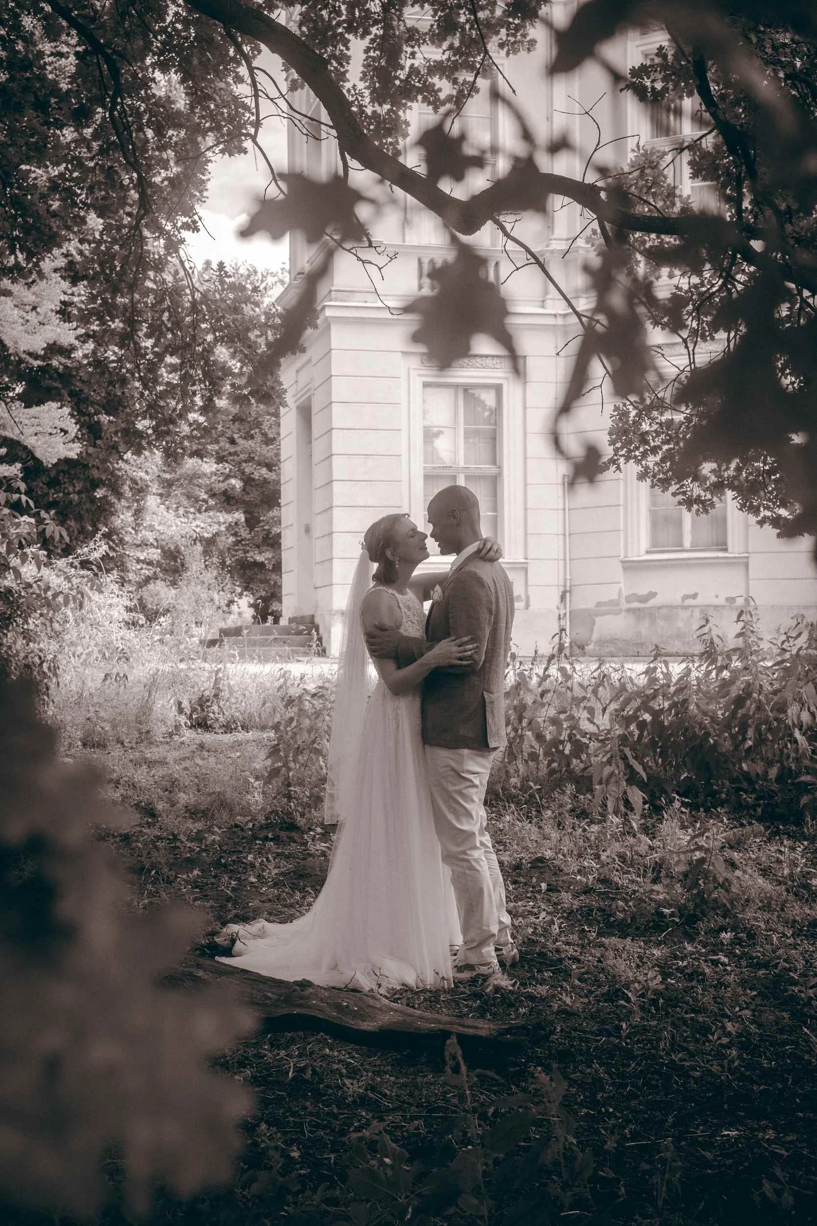 Couple sharing a romantic kiss on the bridge at Schloss Charlottenburg palace, Berlin