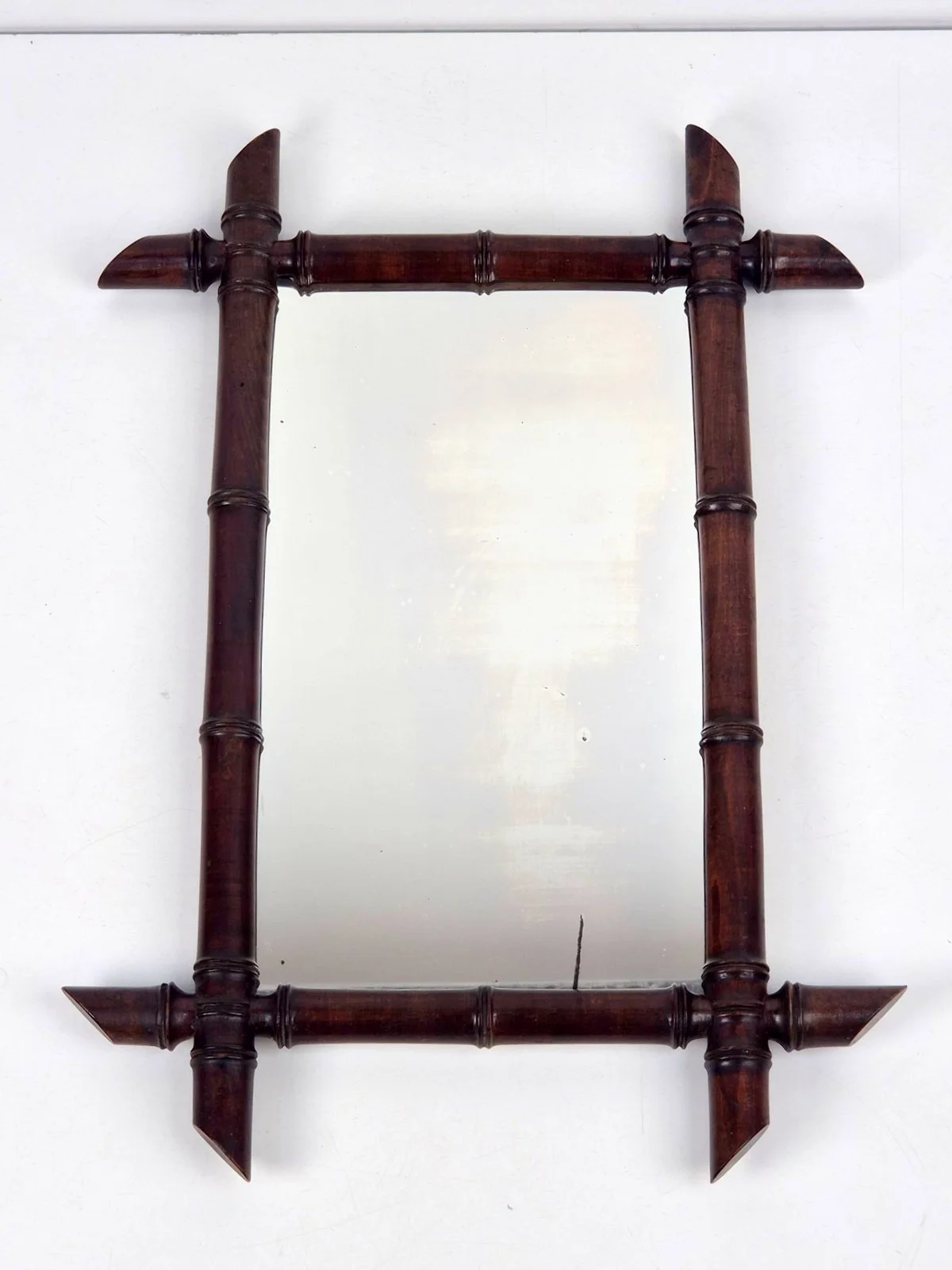 French faux-bamboo mirror with a dark brown, wood-carved frame in Chinoiserie style, 1970
