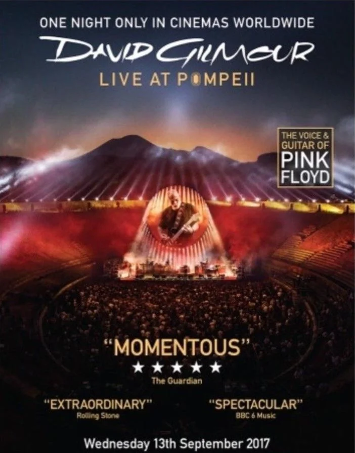 Poster advertising David Gilmour's live concert at Pompeii, with an image of a mountain in the background and a stage with a large crowd in front. The poster mentions Pink Floyd's voice and guitar, and quotes from The Guardian, Rolling Stone, and BBC