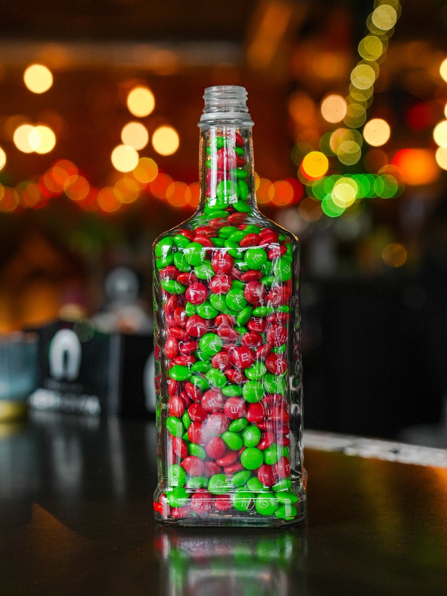Gift card giveaway! Guess how may M&amp;Ms we squeezed into this tequila bottle! Whoever nails it gets a $100 MULA gift card. One guess per person. If no one hits it by Thursday, closest guess wins. #ChristmasInCancun