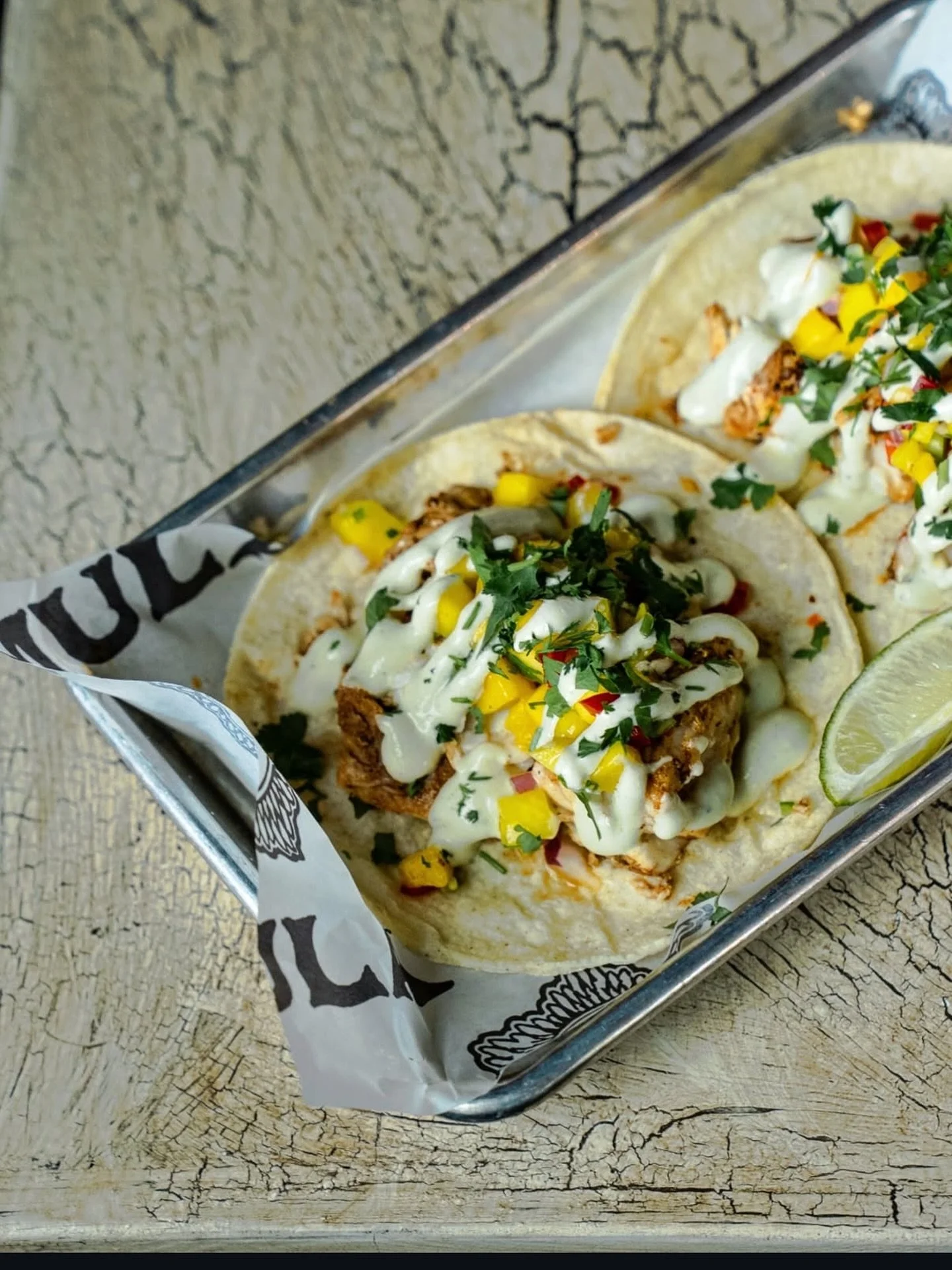 Mahi Tacos today! Spice-rubbed mahi mahi, mango salsa, spicy avocado crema, and cilantro on a corn tortilla. Today only!