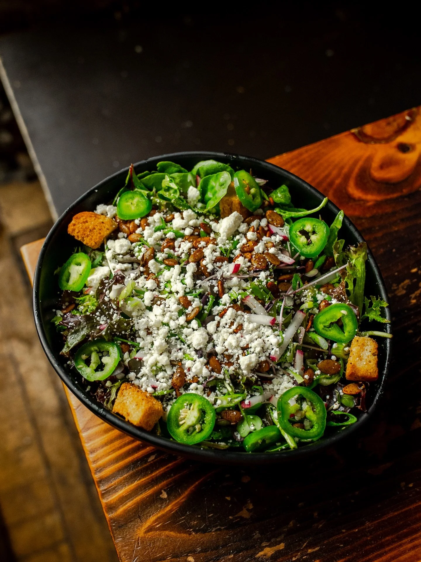 This salad packs a punch. Mixed greens, jalape&ntilde;o, spiced pepitas, radishes, green onions, queso fresco, croutons, and a cilantro-lime vinaigrette. 

Keep it in mind for the summer. 🥗