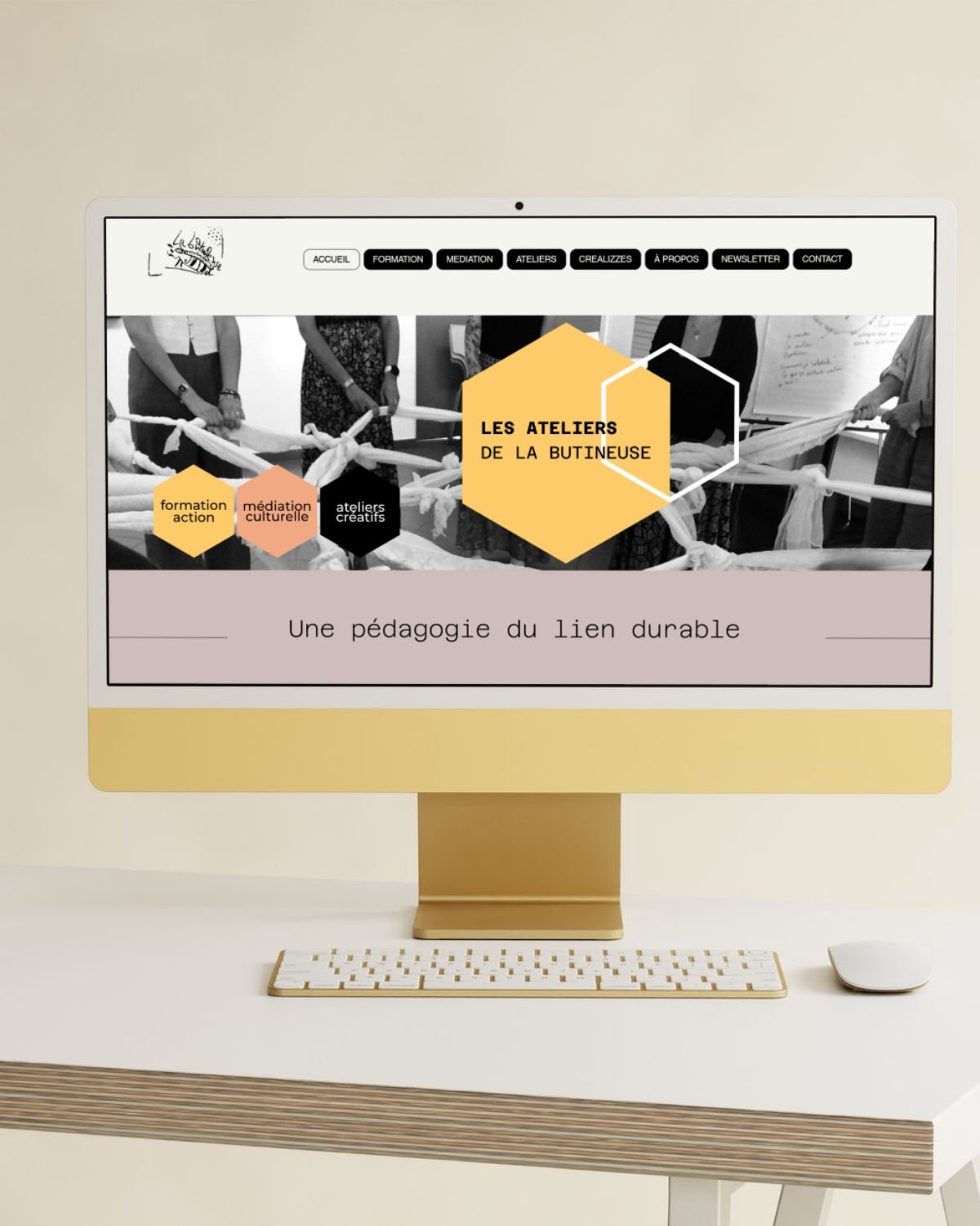Écran d'ordinateur avec une page web présentant des ateliers artistiques nommés "Les Ateliers de la Butineuse". La page contient un bouton "Découvrir" et un menu de navigation en haut.