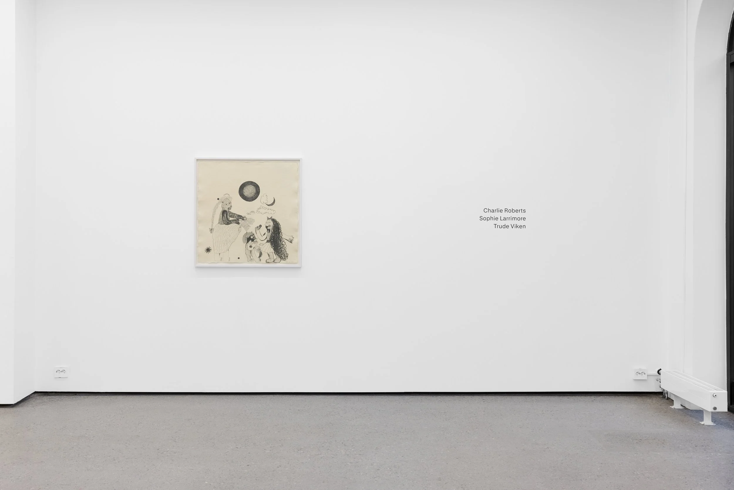 White gallery wall with a single framed artwork featuring abstract figures and symbols, and names of artists Charlie Roberts, Sophie Larrimore, and Trude Viken on the right side.