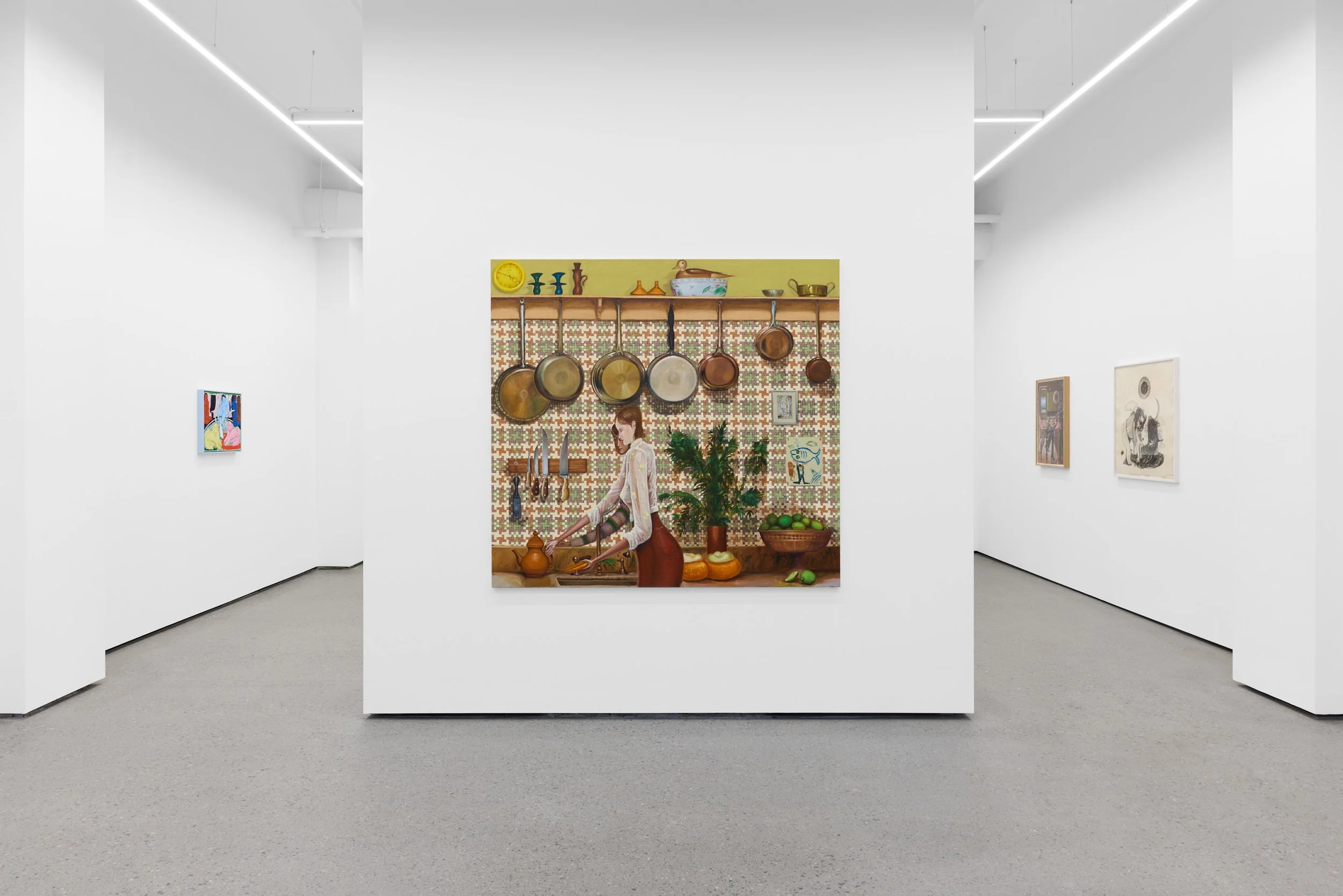 Art gallery with paintings on white walls, featuring a central artwork of a woman in a kitchen surrounded by hanging pots and pans, a plant, and various kitchen items.