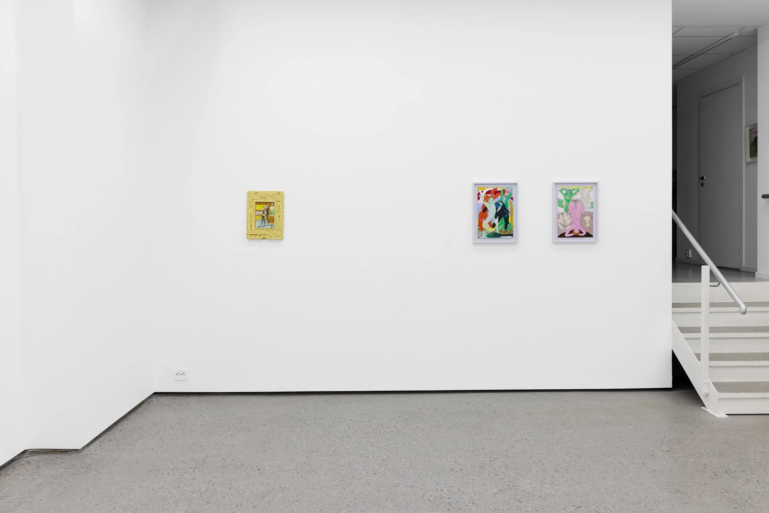 Three colorful abstract art pieces displayed on a white gallery wall, with a staircase on the right side.