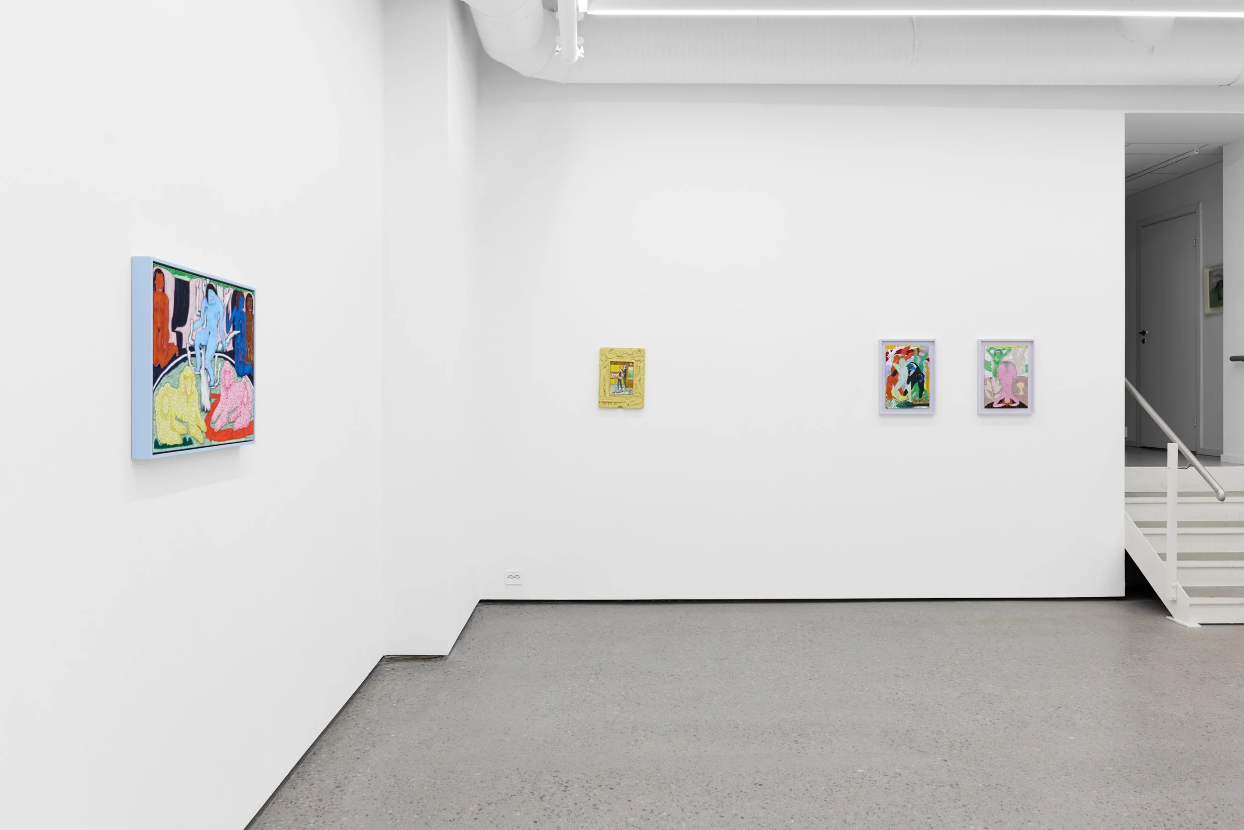 Art gallery with four colorful paintings on white walls and a staircase on the right side.