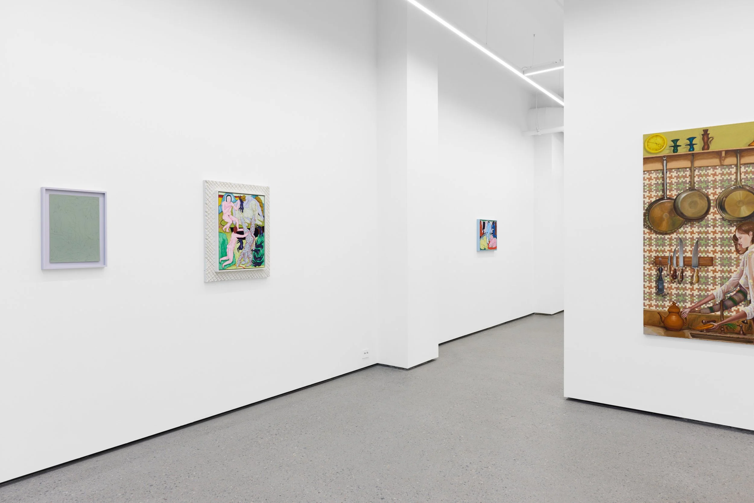 White-walled art gallery exhibiting colorful paintings, with a visible kitchen scene painting on the corner wall featuring a woman cooking and hanging kitchen utensils.