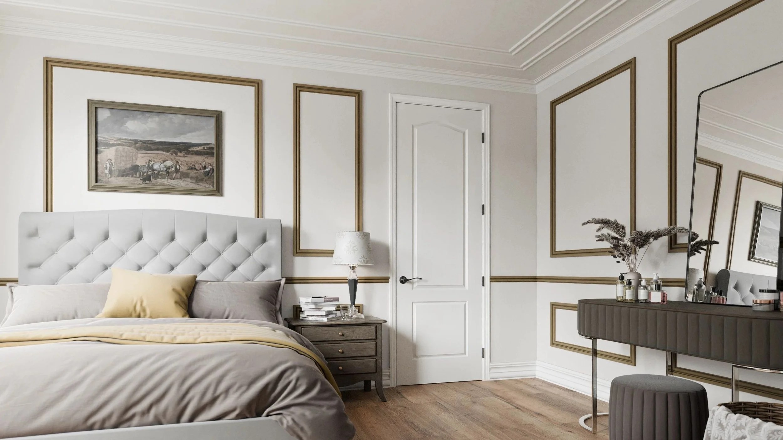 A bedroom with a white tufted headboard, beige and gray bedding, a wooden nightstand with books and a table lamp, a dresser with various bottles and dried flowers, a large angled mirror, and framed artwork on the walls.