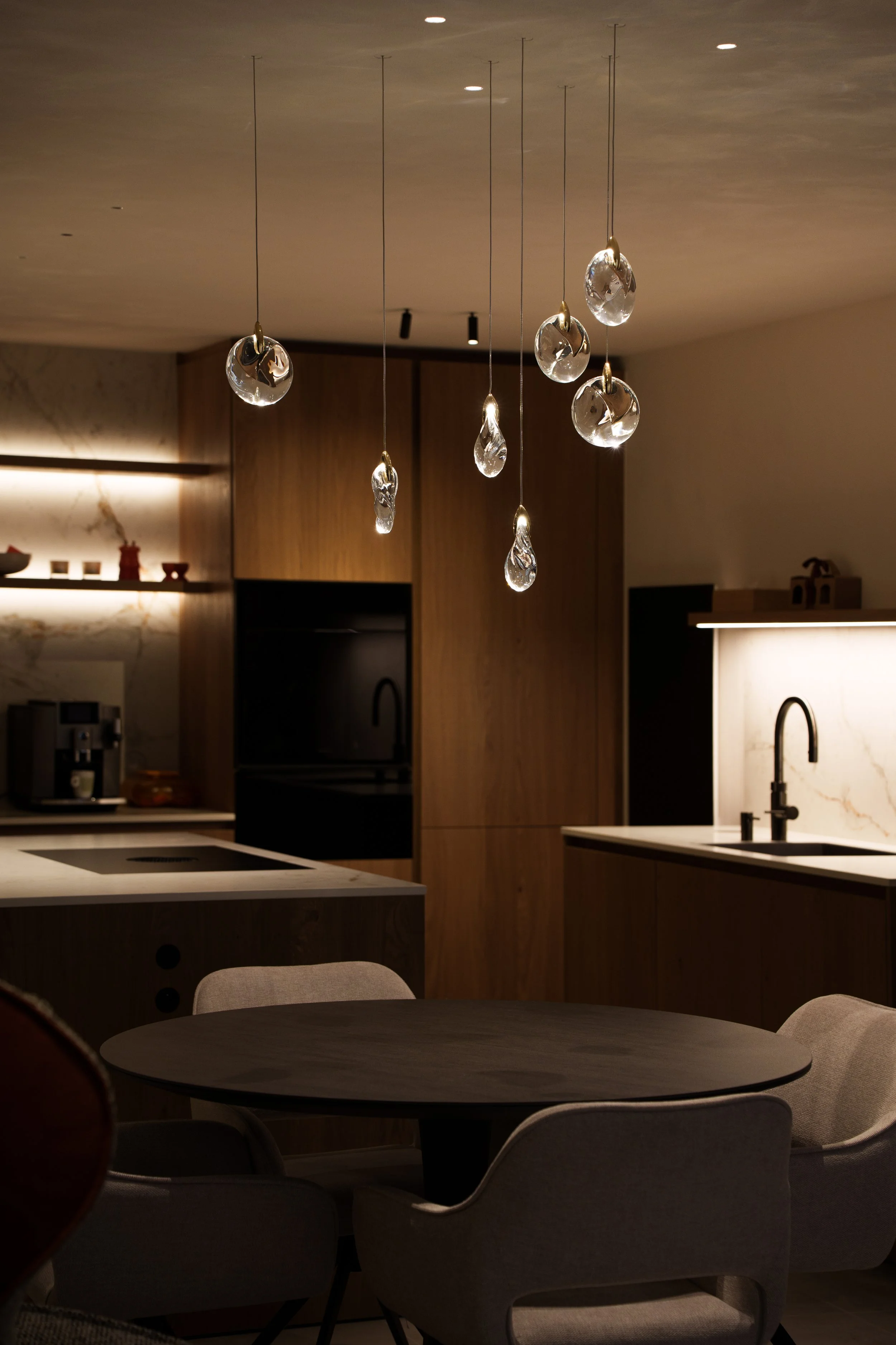 Elegant crystal composition chandelier above a dining table, creating a luxurious ambiance and enhancing modern interior design