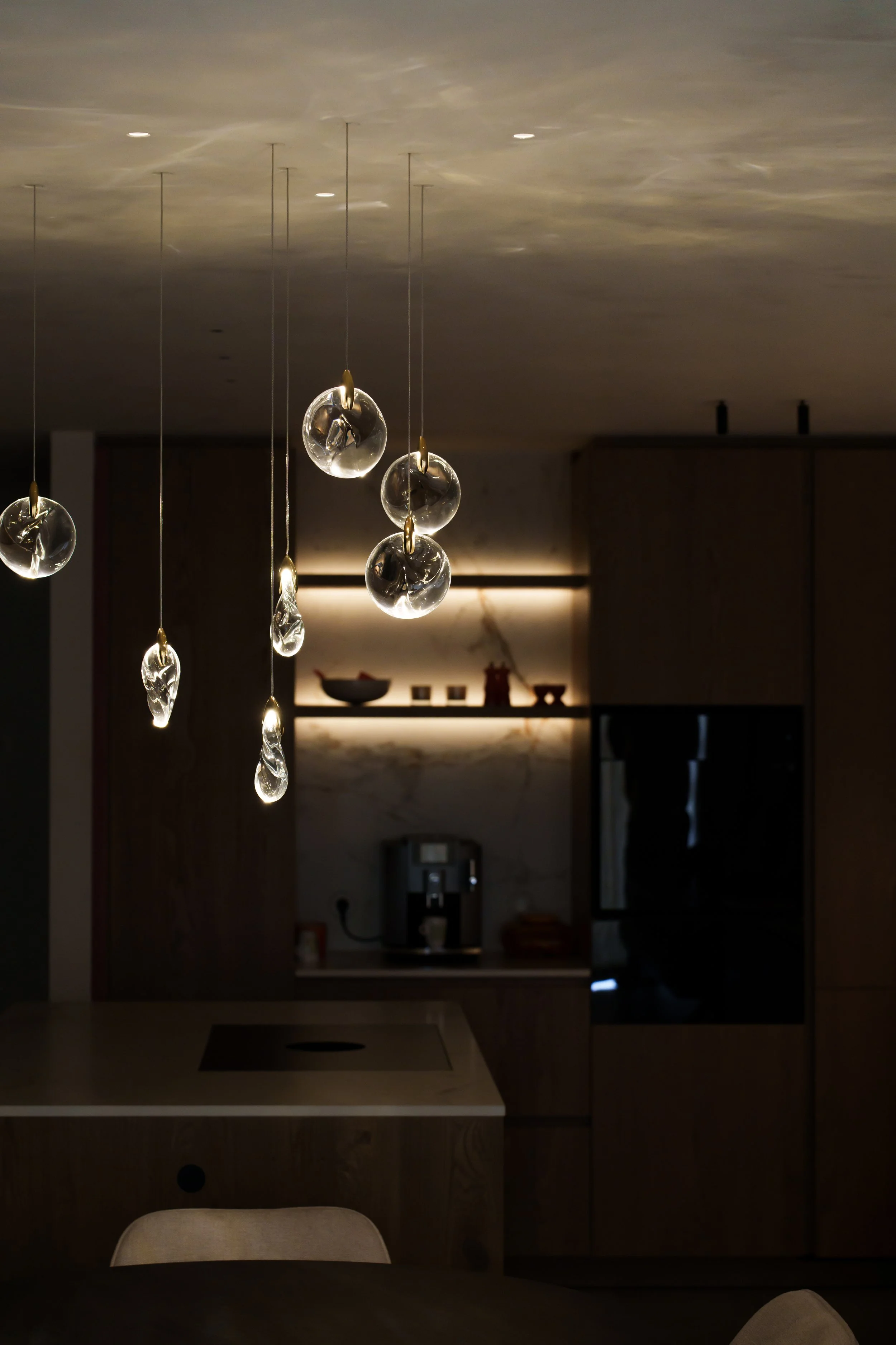 Elegant crystal composition chandelier above a dining table, creating a luxurious ambiance and enhancing modern interior design