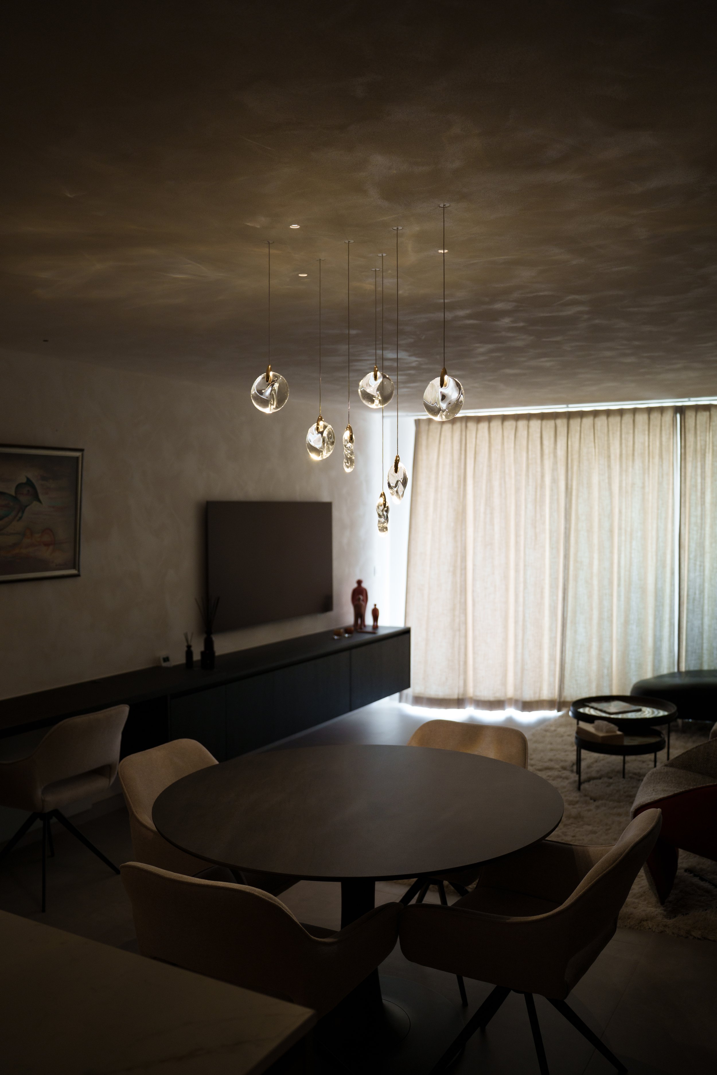 Elegant crystal composition chandelier above a dining table, creating a luxurious ambiance and enhancing modern interior design