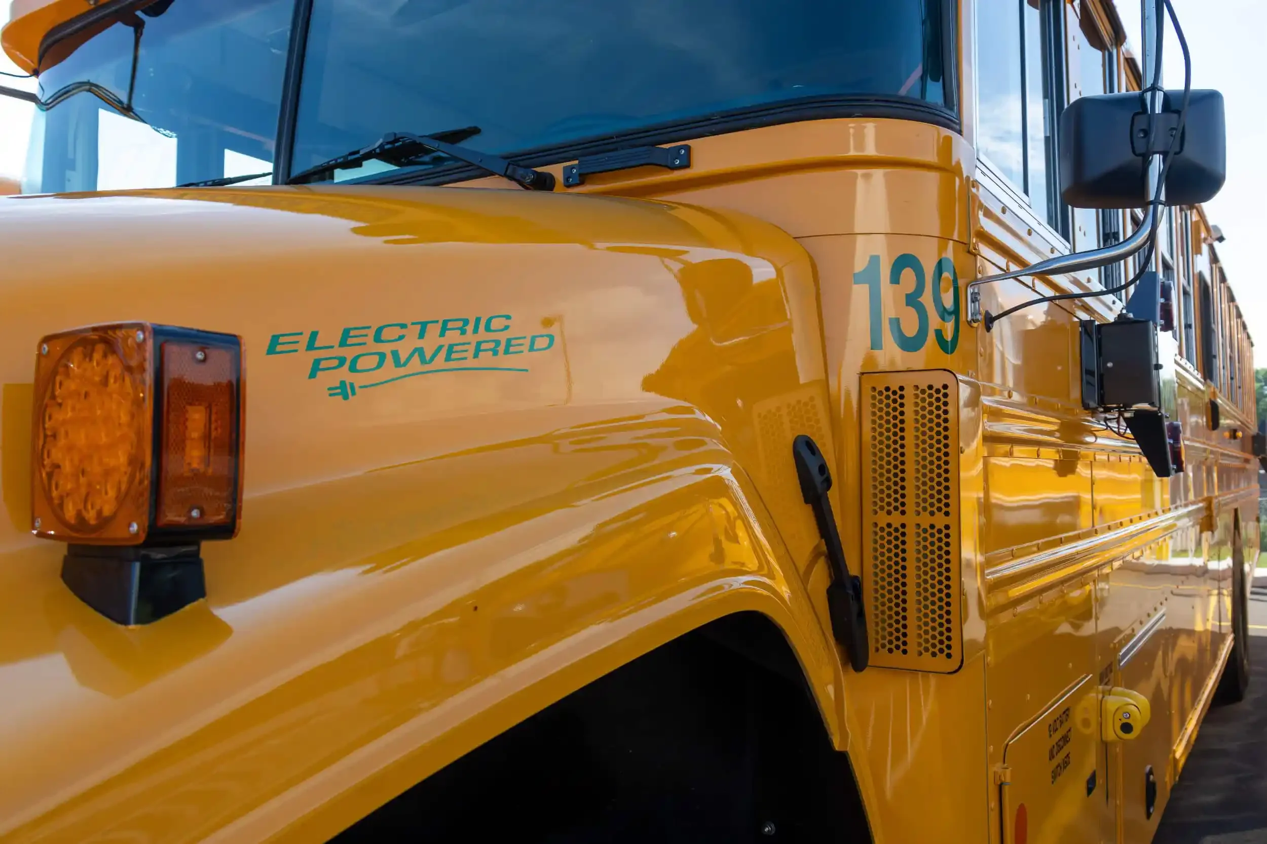 A closeup of an electric powered bus showing the logo "Electric Powered"