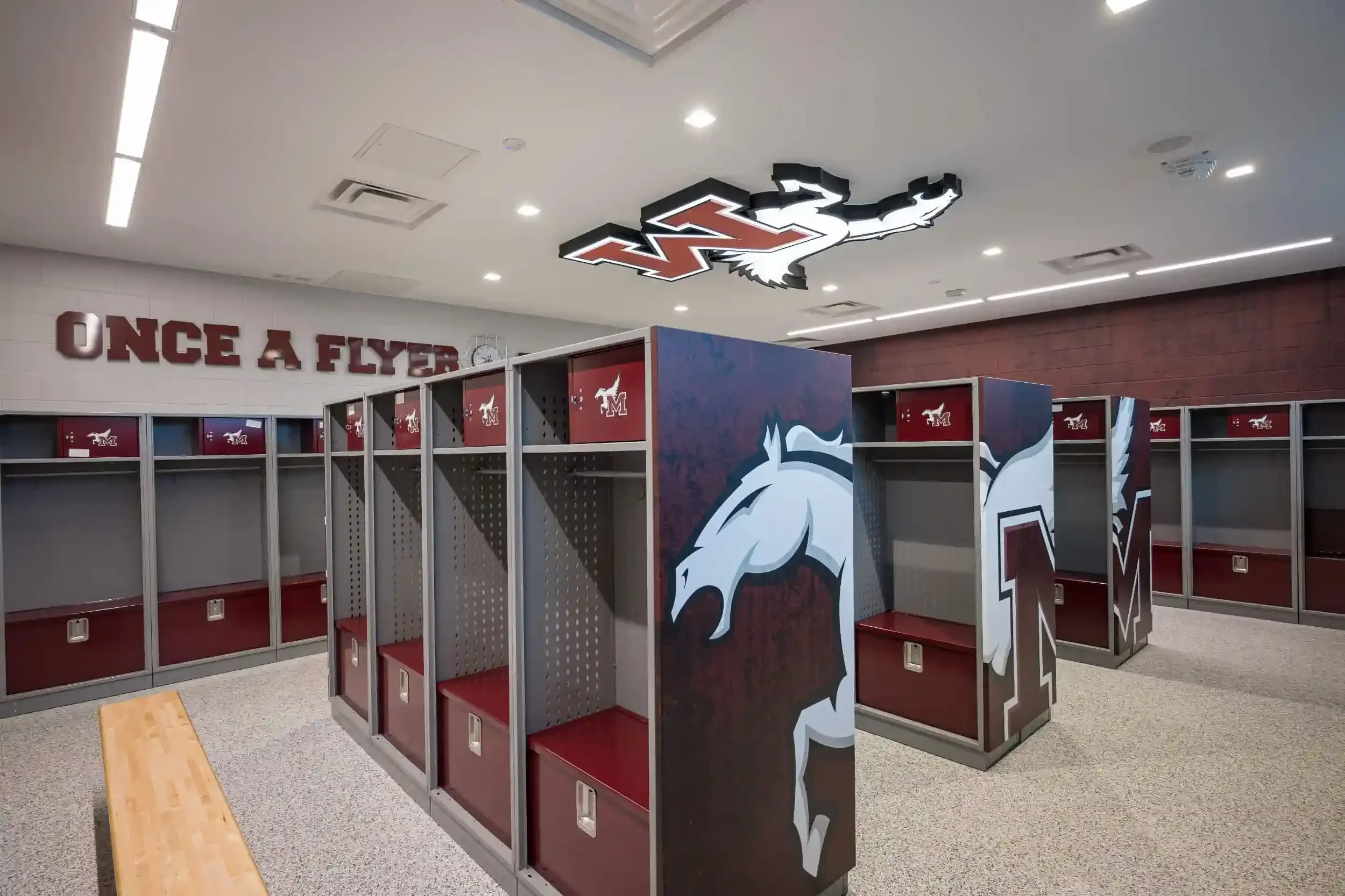 A view of the new locker room with the school's logo on the ceiling