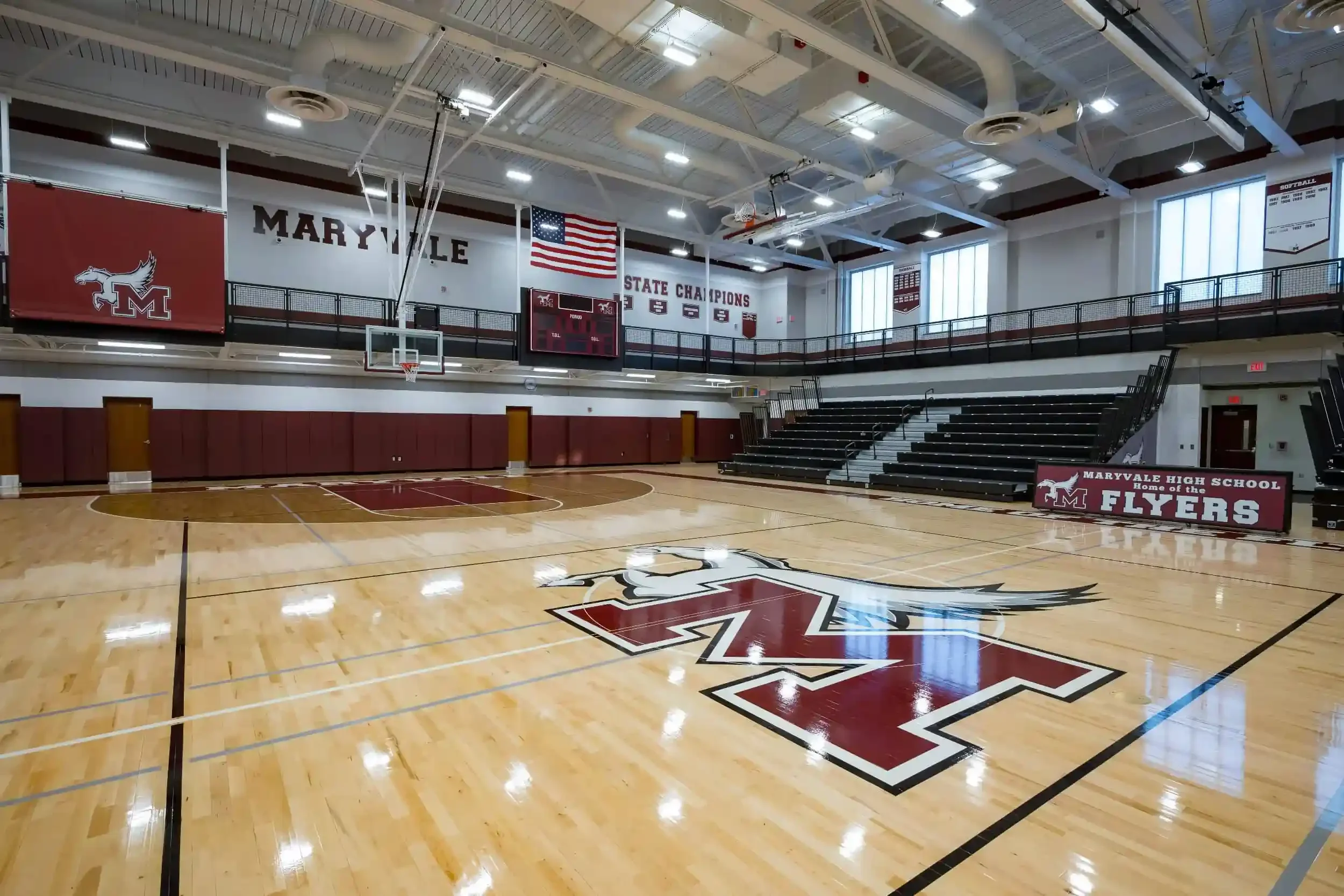 A view of the new gymnasium floor with the school's logo in the foreground